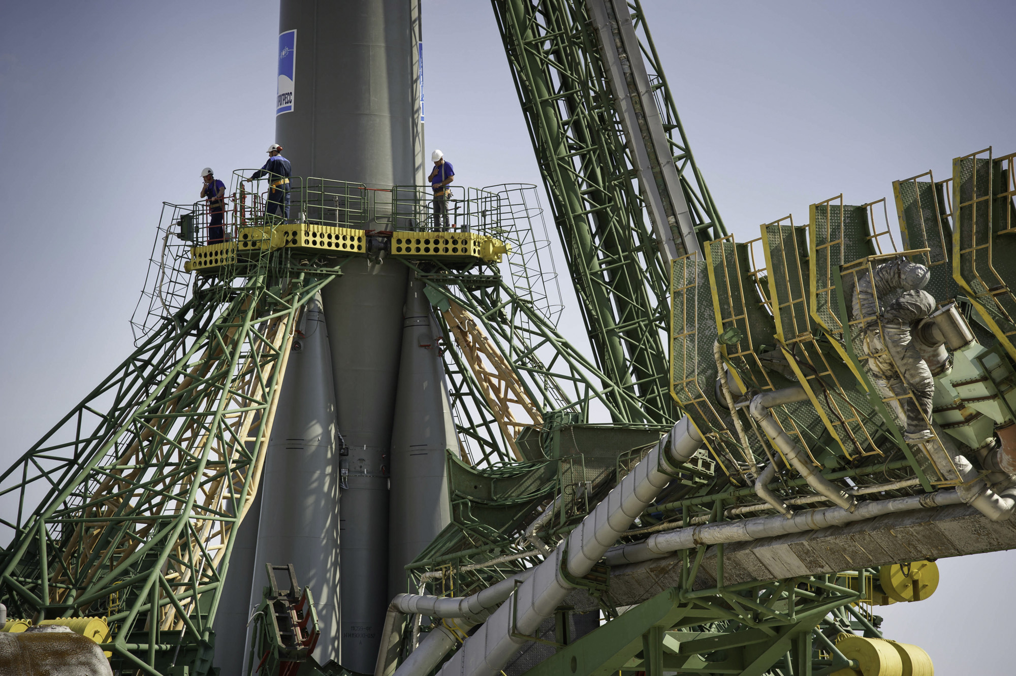 Launch pad engineers at the Baikonur Cosmodrome in Kazakhstan are dwarfed by the large gantry mechanisms at the base of the Soyuz TMA-02M rocket following its rollout to the pad on Sunday, June 5, 2011. The rocket is being prepared for launch June 8