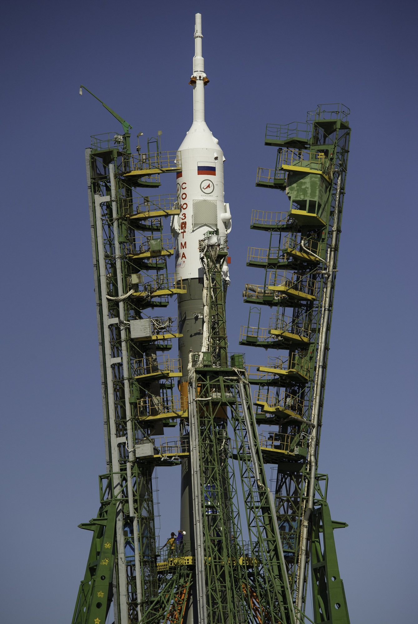  Large gantry mechanisms on either side of the Soyuz TMA-205M spacecraft are raised into position to secure the rocket at the launch pad on Thursday, July 12, 2012 at the Baikonur Cosmodrome in Kazakhstan. (NASA/Carla Cioffi) 