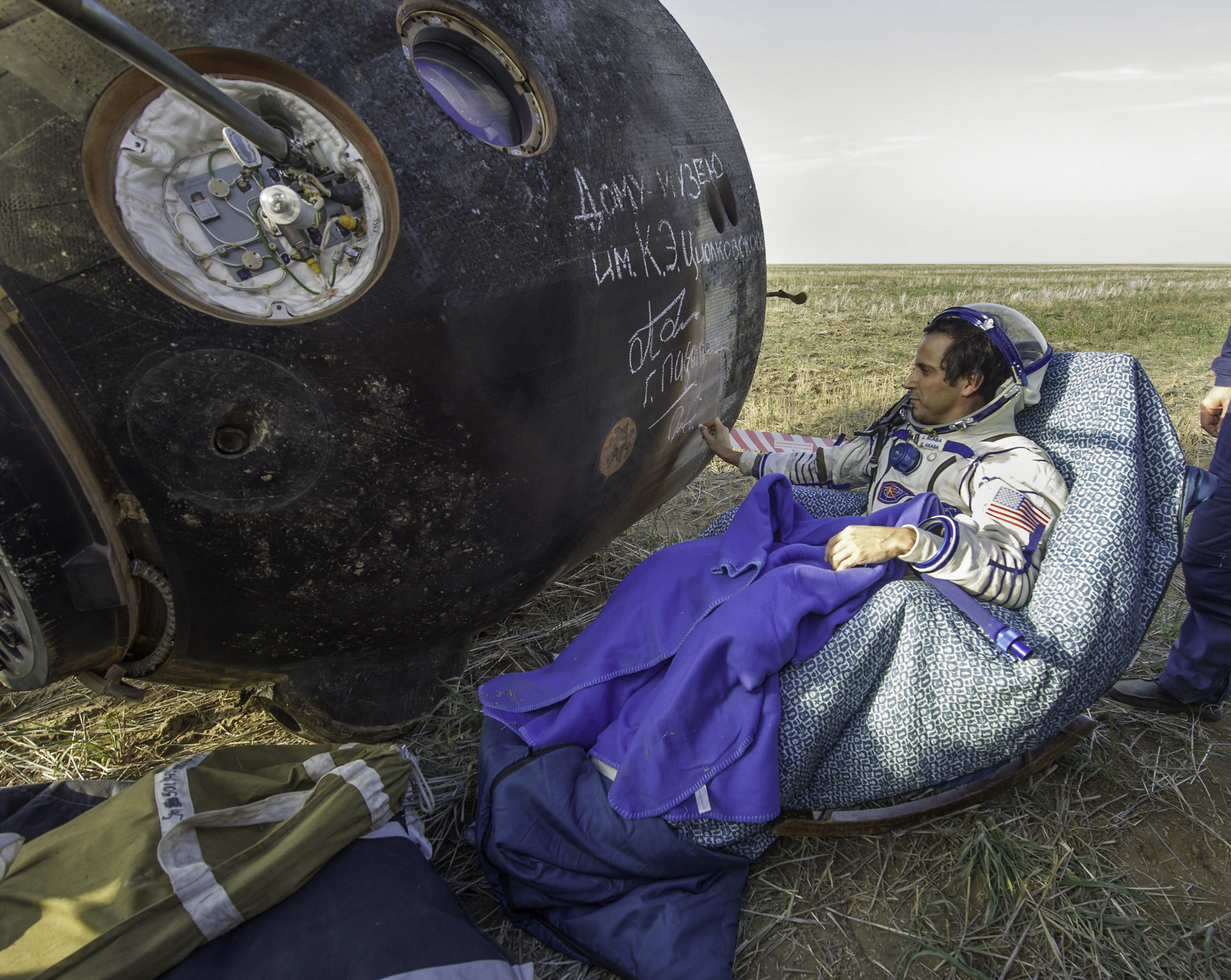  Expedition 32 NASA Flight Engineer signs the side of his Soyuz TMA-04M spacecraft shortly after he landed with his crew mates Expedition 32 Commander Gennady Padalka and Flight Engineer Sergei Revin of Russia in a remote area near the town of Arkaly
