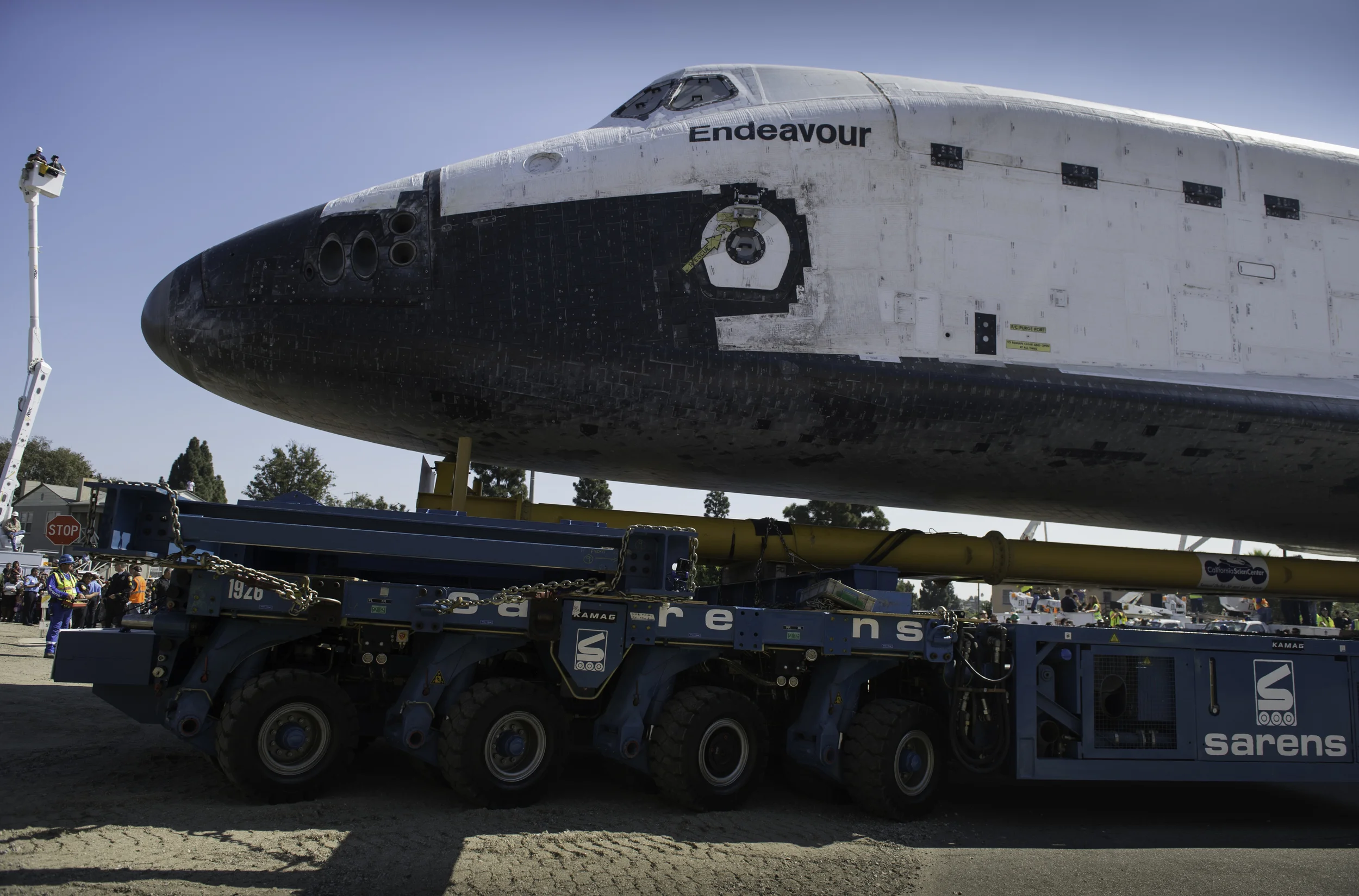 The space shuttle Endeavour is seen as it is maneuvered through the streets of Inglewood on its way to its new home at the California Science Center, Saturday, Oct. 13, 2012. Endeavour, built as a replacement for space shuttle Challenger, completed 25 missions, spent 299 days in orbit, and orbited Earth 4,671 times while traveling 122,883,151 miles. Beginning Oct. 30, the shuttle will be on display in the CSC’s Samuel Oschin Space Shuttle Endeavour Display Pavilion, embarking on its new mission to commemorate past achievements in space and educate and inspire future generations of explorers. (NASA/Carla Cioffi)