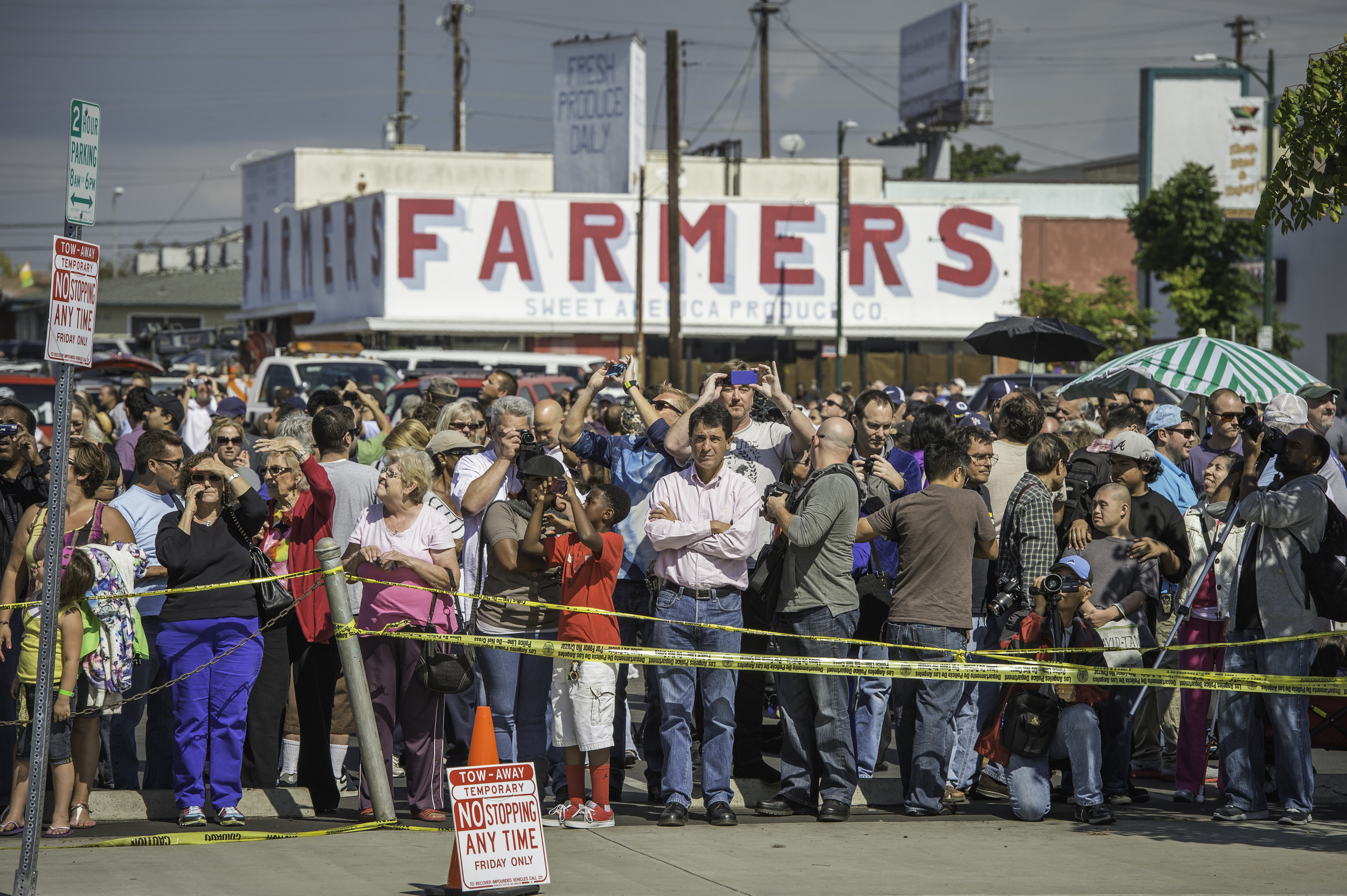  Spectators gather to watch space shuttle Endeavour as it passes by on its way to its new home at the California Science Center in Los Angeles, Friday, Oct. 12, 2012. Endeavour, built as a replacement for space shuttle Challenger, completed 25 missio