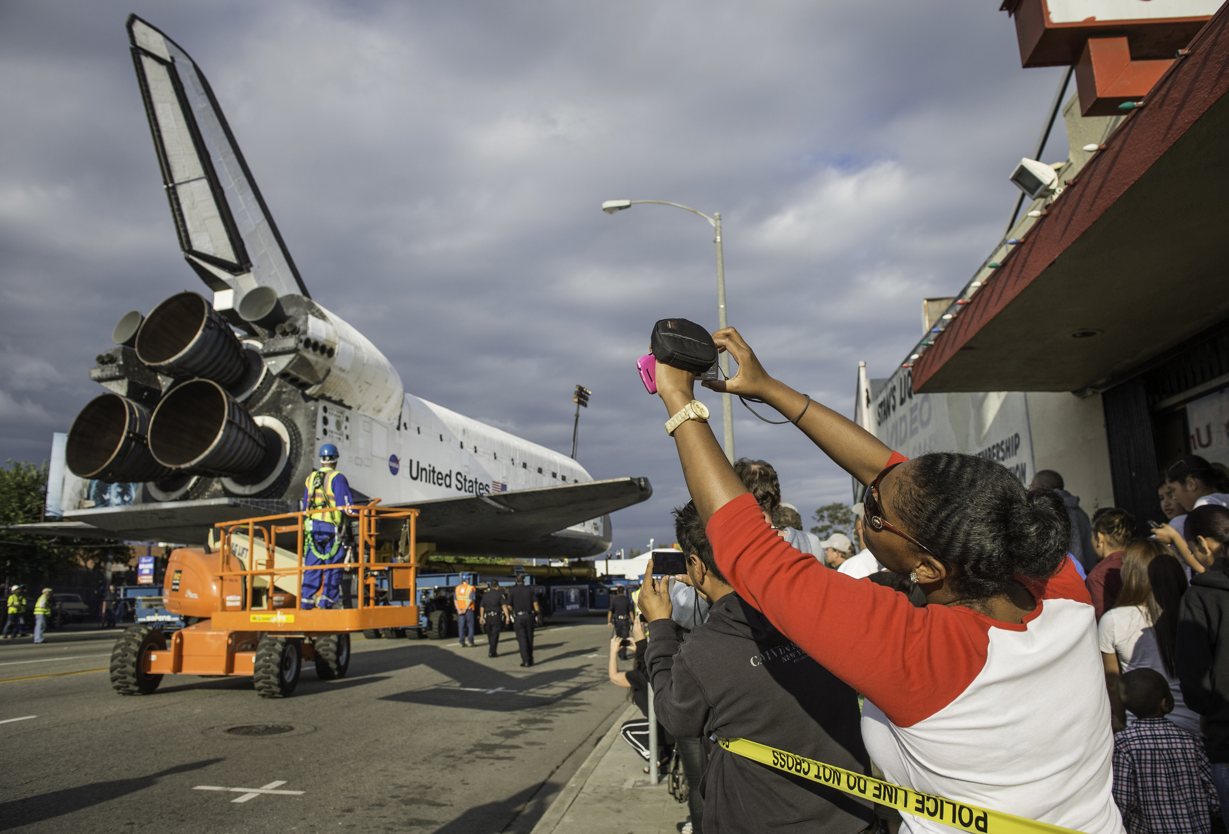  Spectators are seen photographing space shuttle Endeavour as it passes by on its way to its new home at the California Science Center, Friday, Oct. 12, 2012, in Inglewood. Endeavour, built as a replacement for space shuttle Challenger, completed 25 