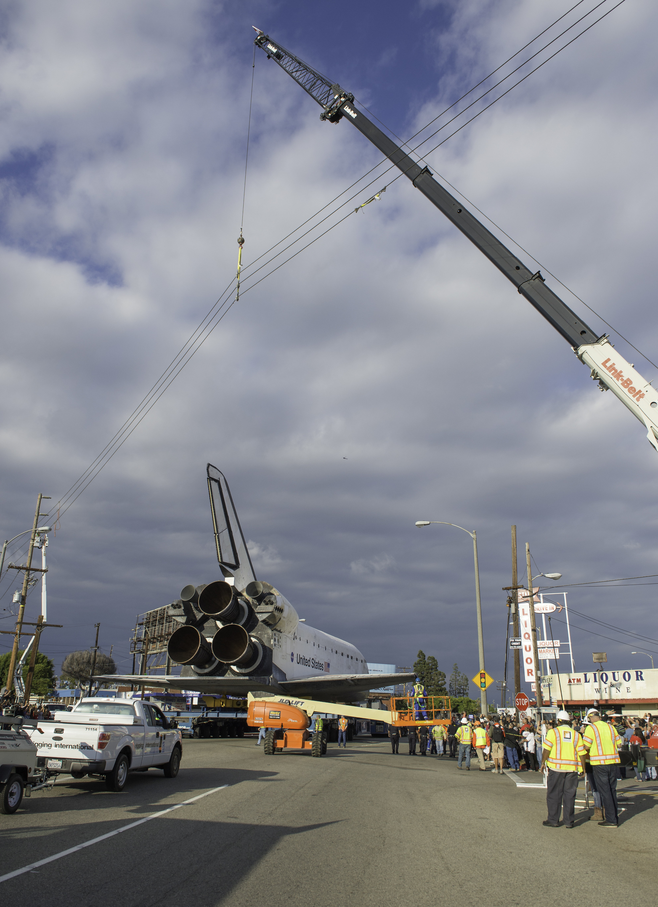 Power lines are hoisted upwards by a crane in order to allow the space shuttle Endeavour to traverse on its path to its new home at the California Science Center, Friday, Oct. 12, 2012 in Inglewood. Endeavour, built as a replacement for space shuttl