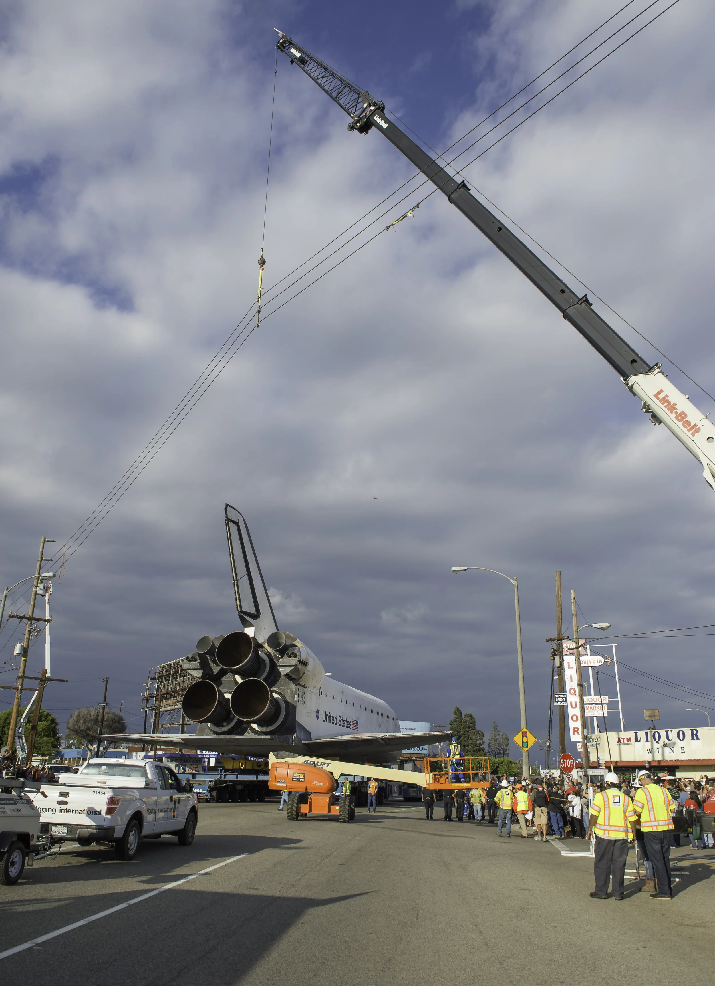 Power lines are hoisted upwards by a crane in order to allow the space shuttle Endeavour to traverse on its path to its new home at the California Science Center, Friday, Oct. 12, 2012 in Inglewood. Endeavour, built as a replacement for space shuttle Challenger, completed 25 missions, spent 299 days in orbit, and orbited Earth 4,671 times while traveling 122,883,151 miles. Beginning Oct. 30, the shuttle will be on display in the CSC’s Samuel Oschin Space Shuttle Endeavour Display Pavilion, embarking on its new mission to commemorate past achievements in space and educate and inspire future generations of explorers. (NASA/Carla Cioffi)