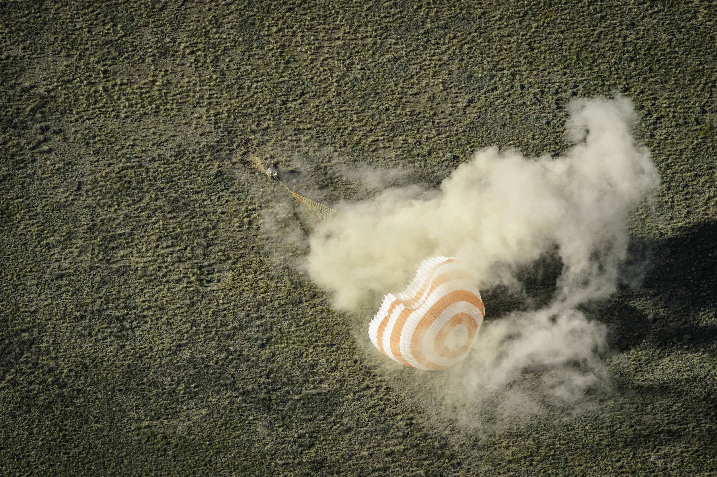 The Soyuz TMA-07M spacecraft is seen as it lands with Expedition 35 Commander Chris Hadfield of the Canadian Space Agency (CSA), NASA Flight Engineer Tom Marshburn and Russian Flight Engineer Roman Romanenko of the Russian Federal Space Agency (Roscosmos) in a remote area near the town of Zhezkazgan, Kazakhstan, on Tuesday, May 14, 2013. Hadfield, Marshburn and Romanenko returned from five months onboard the International Space Station where they served as members of the Expedition 34 and 35 crews. (NASA/Carla Cioffi)