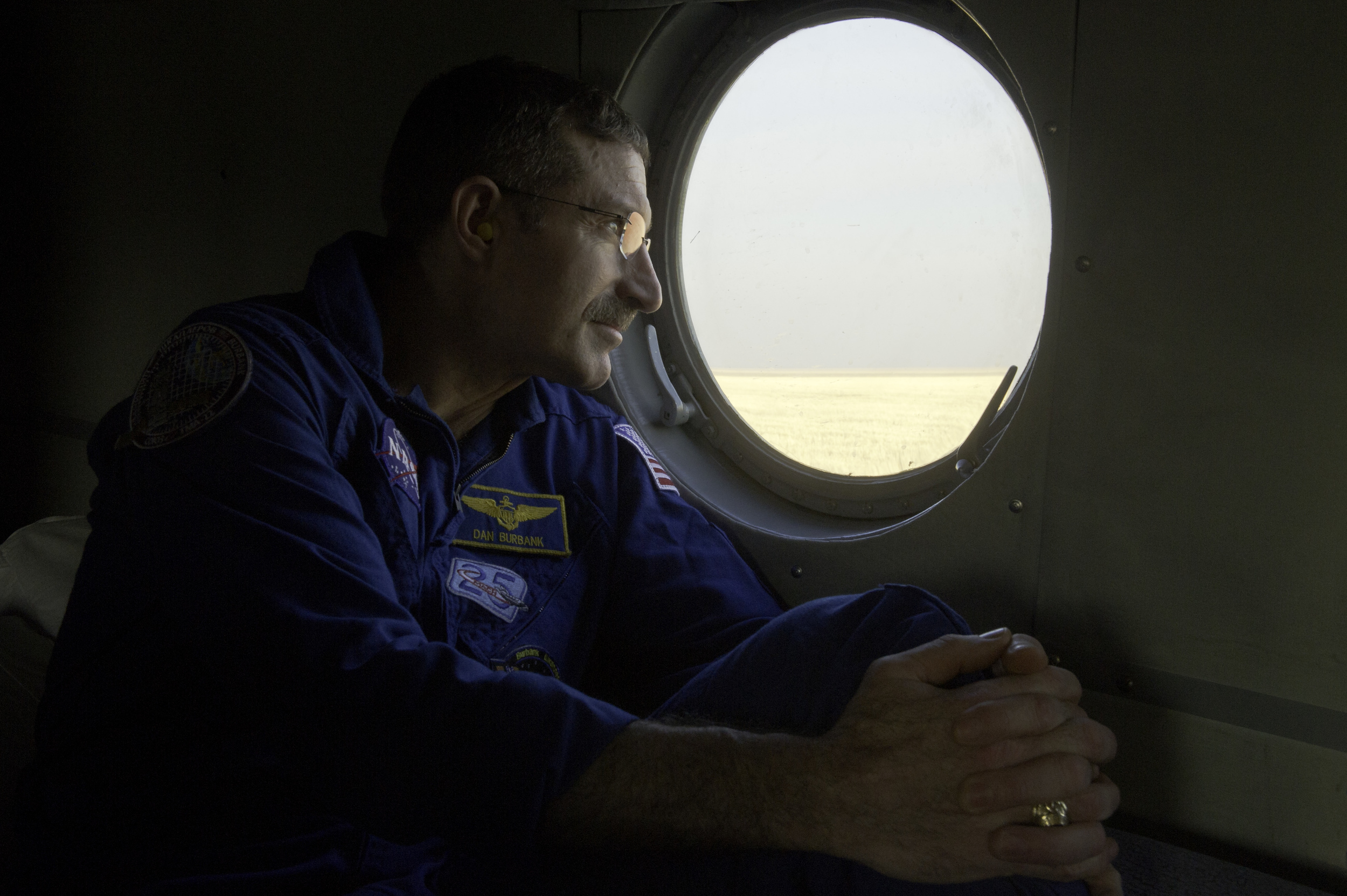  Expedition 30 Commander Dan Burbank looks out the window of his helicopter as it prepares to depart for Kustanai from the Soyuz TMA-22 capsule landing site outside of the town of Arkalyk, Kazakhstan on Friday, April 27, 2012. Astronaut Burbank, Russ