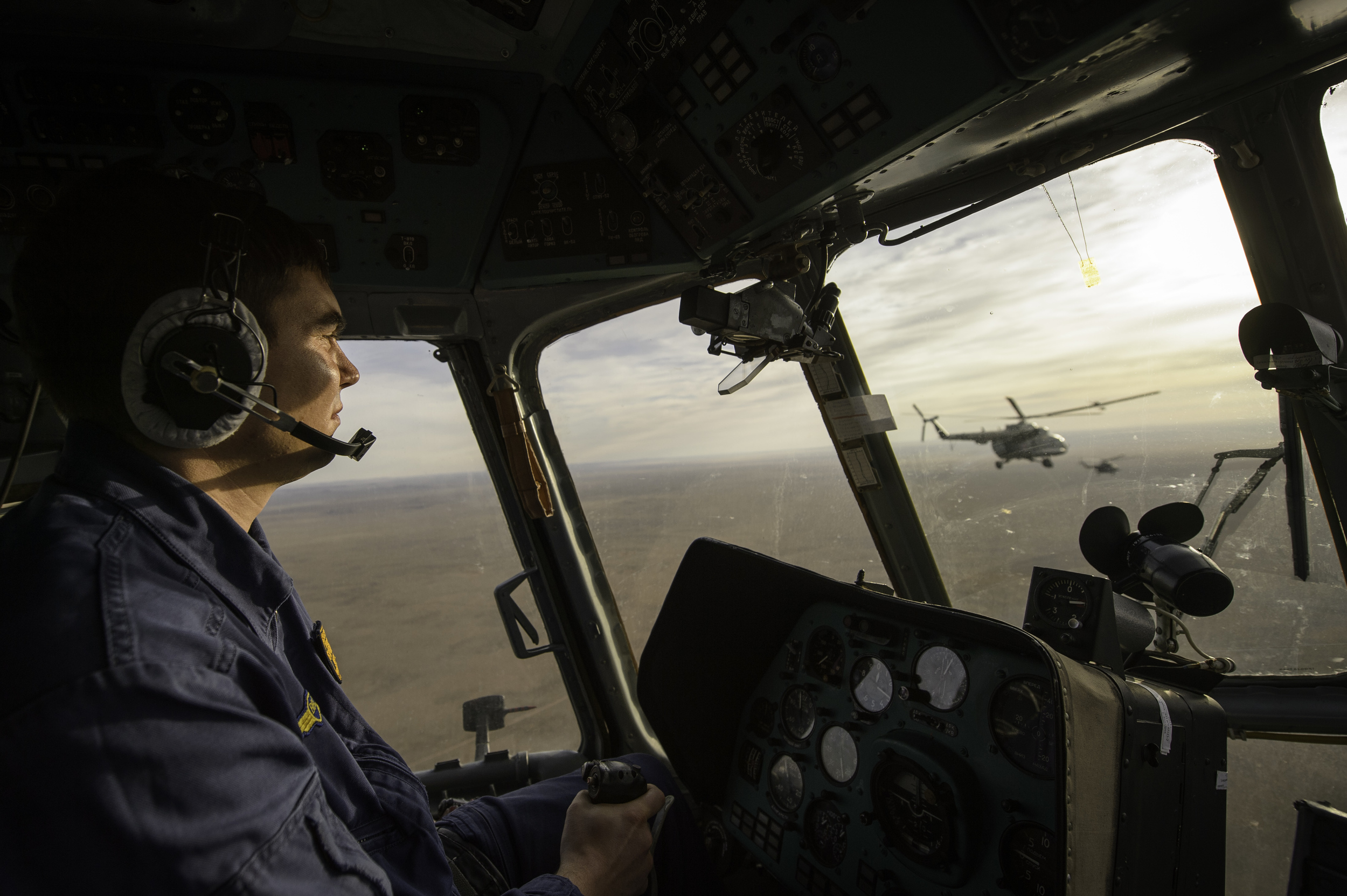  A Russian search and rescue helicopter co-pilot is seen in the cockpit of his helicopter en route to Zhezkazgan airport in Kazakhstan, Sunday, Nov. 10, 2013, a day ahead of the scheduled landing of the Soyuz TMA-09M spacecraft with Expedition 37 Com