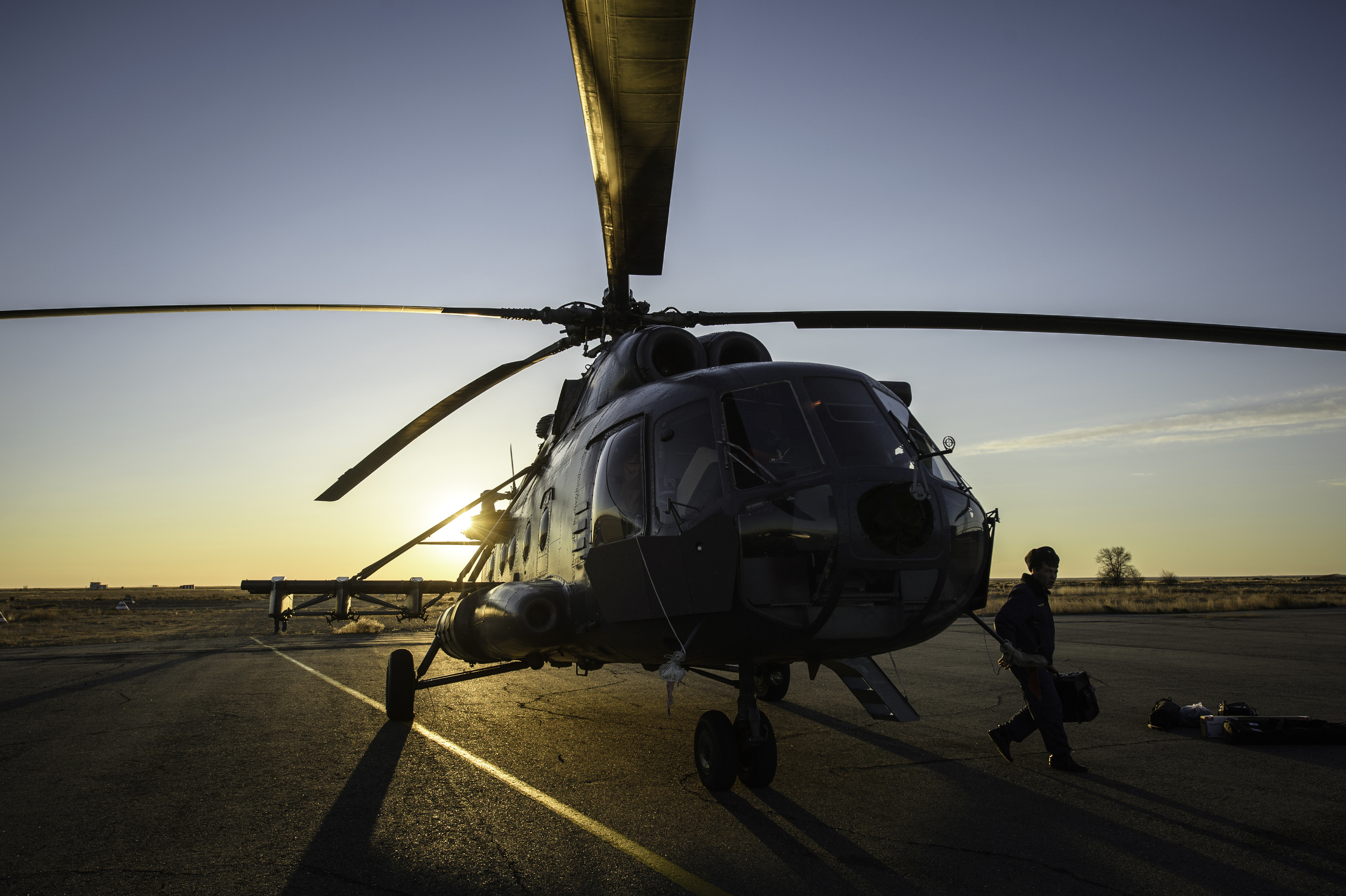  A member of Russian search and rescue exits a helicopter moments after landing at Zhezkazgan airport in Kazakhstan, Sunday, Nov. 10, 2013, a day ahead of the scheduled landing of the Soyuz TMA-09M spacecraft with Expedition 37 Commander Fyodor Yurch