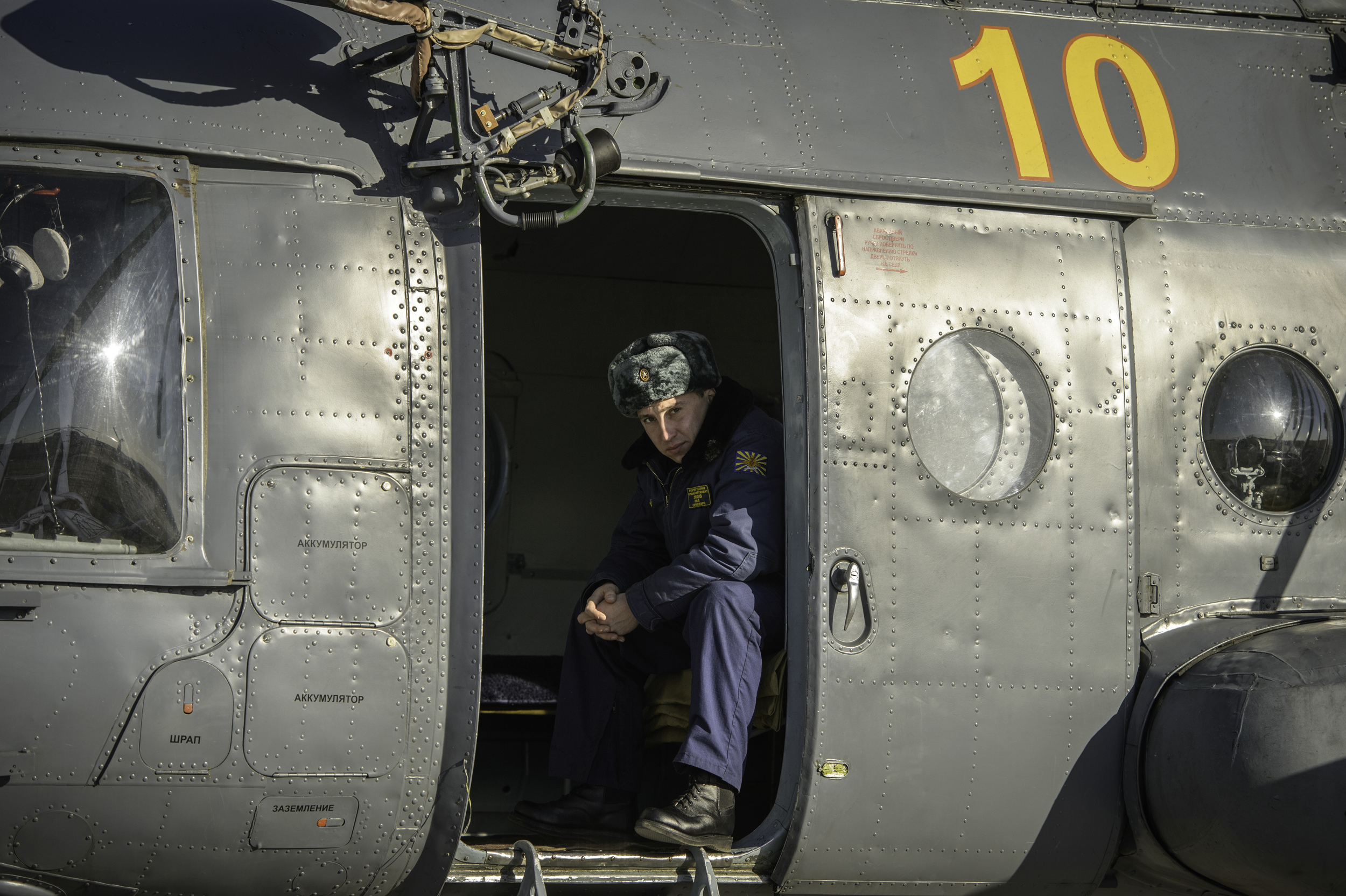  A member of Russian search and rescue is seen in his helicopter after landing at Zhezkazgan airport in Kazakhstan, Sunday, Nov. 10, 2013, a day ahead of the scheduled landing of the Soyuz TMA-09M spacecraft with Expedition 37 Commander Fyodor Yurchi