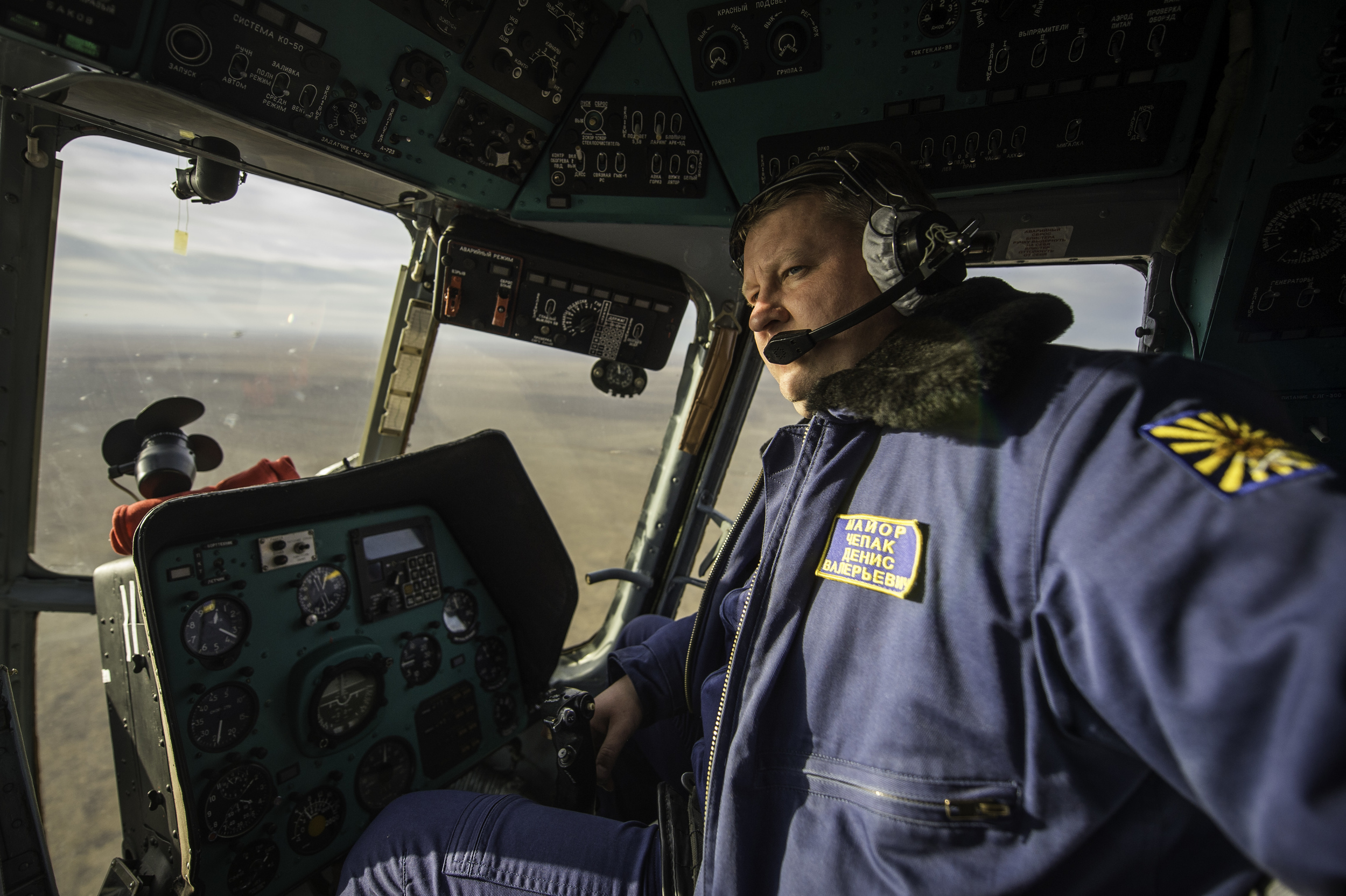  Major Dennis Valeriyavich Chepak, of Russian Search and Rescue, is seen in the cockpit of his helicopter en route to Zhezkazgan airport in Kazakhstan, Sunday, Nov. 10, 2013, a day ahead of the scheduled landing of the Soyuz TMA-09M spacecraft with E