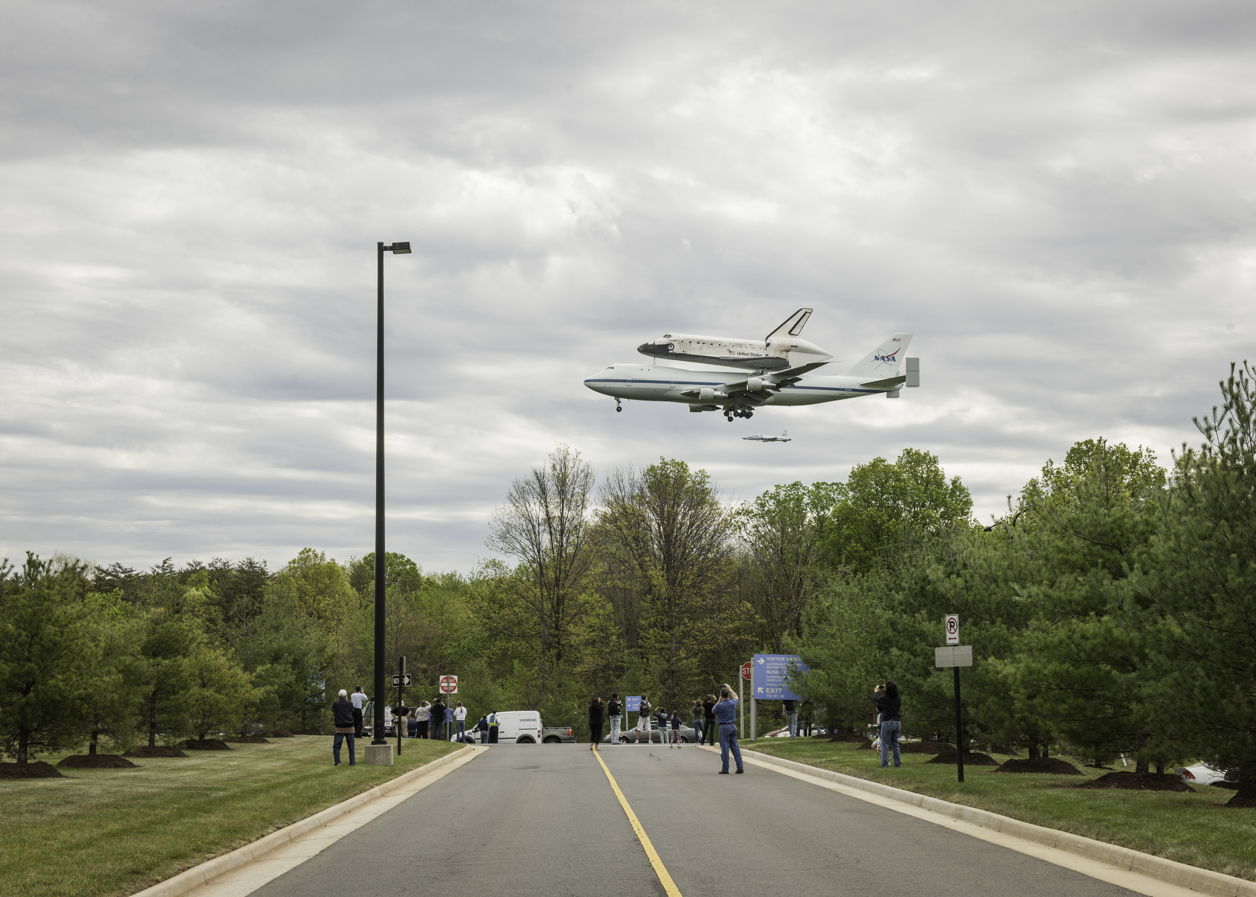  Space shuttle Discovery, mounted atop a NASA 747 Shuttle Carrier Aircraft (SCA), flies over the National Air and Space Museum’s Steven F. Udvar-Hazy Center, Tuesday, April 17, 2012, in Chantilly, Va. Discovery, the first orbiter retired from NASA’s 