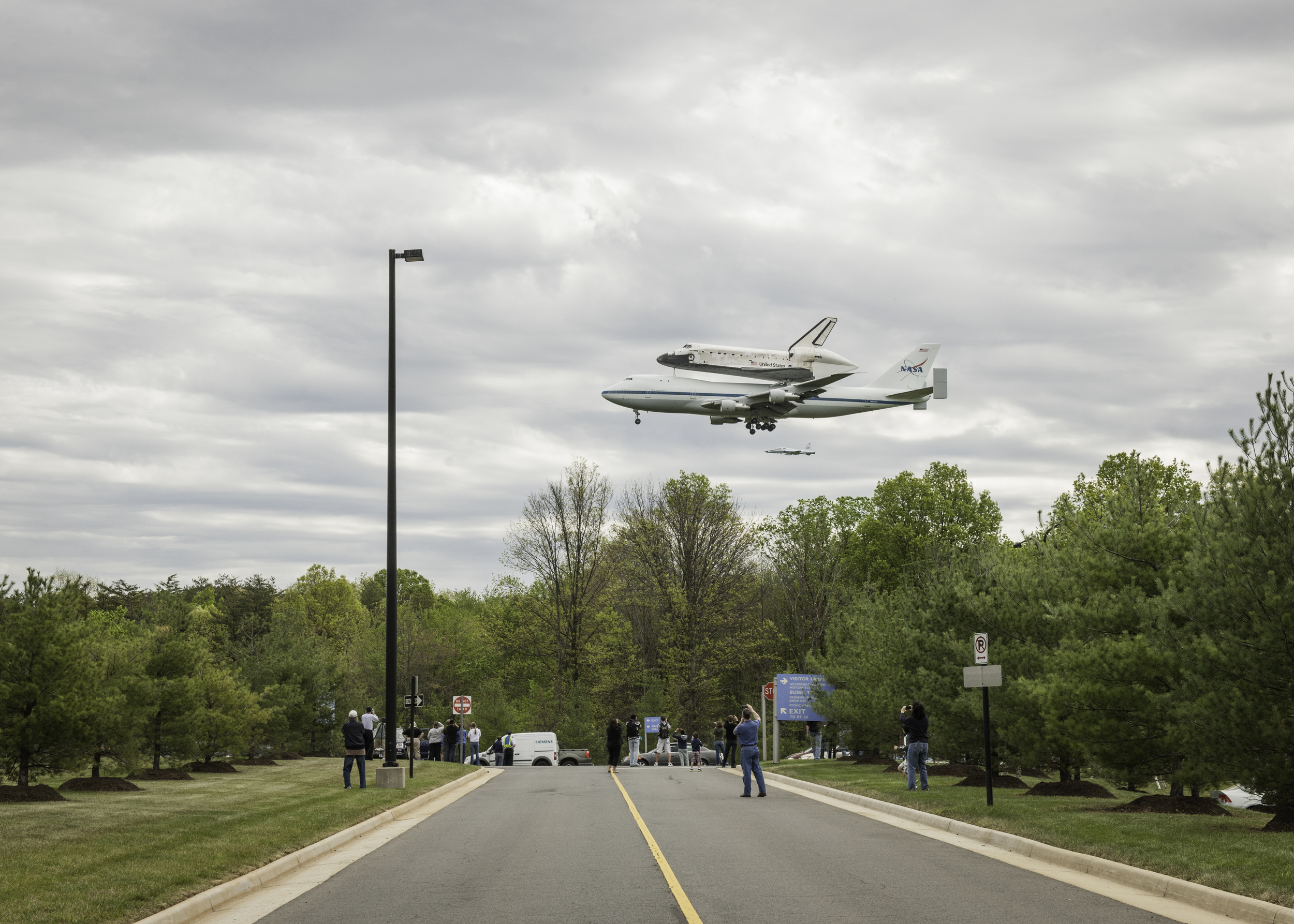 Space shuttle Discovery, mounted atop a NASA 747 Shuttle Carrier Aircraft (SCA), flies over the National Air and Space Museum’s Steven F. Udvar-Hazy Center, Tuesday, April 17, 2012, in Chantilly, Va. Discovery, the first orbiter retired from NASA’s