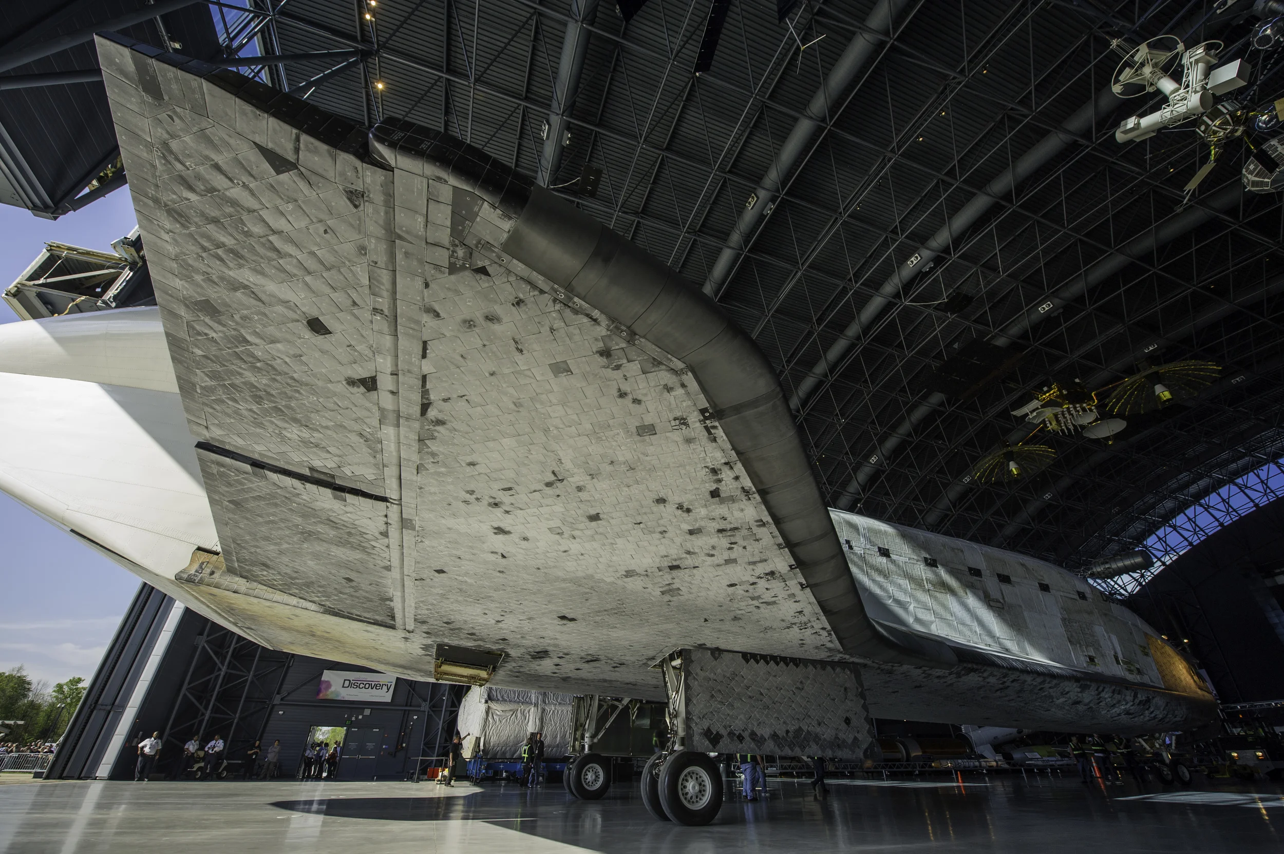 Space shuttle Discovery is rolled into its hangar at the Steven F. Udvar-Hazy Center Thursday, April 19, 2012 in Chantilly, Va. Discovery will be permanently housed at the Udvar-Hazy Center, part of the Smithsonian Institution’s Air and Space Museum. Discovery, the first orbiter retired from NASA’s shuttle fleet, completed 39 missions, spent 365 days in space, orbited the Earth 5,830 times, and traveled 148,221,675 miles. NASA will transfer Discovery to the National Air and Space Museum to begin its new mission to commemorate past achievements in space and to educate and inspire future generations of explorers. (NASA/Carla Cioffi)
