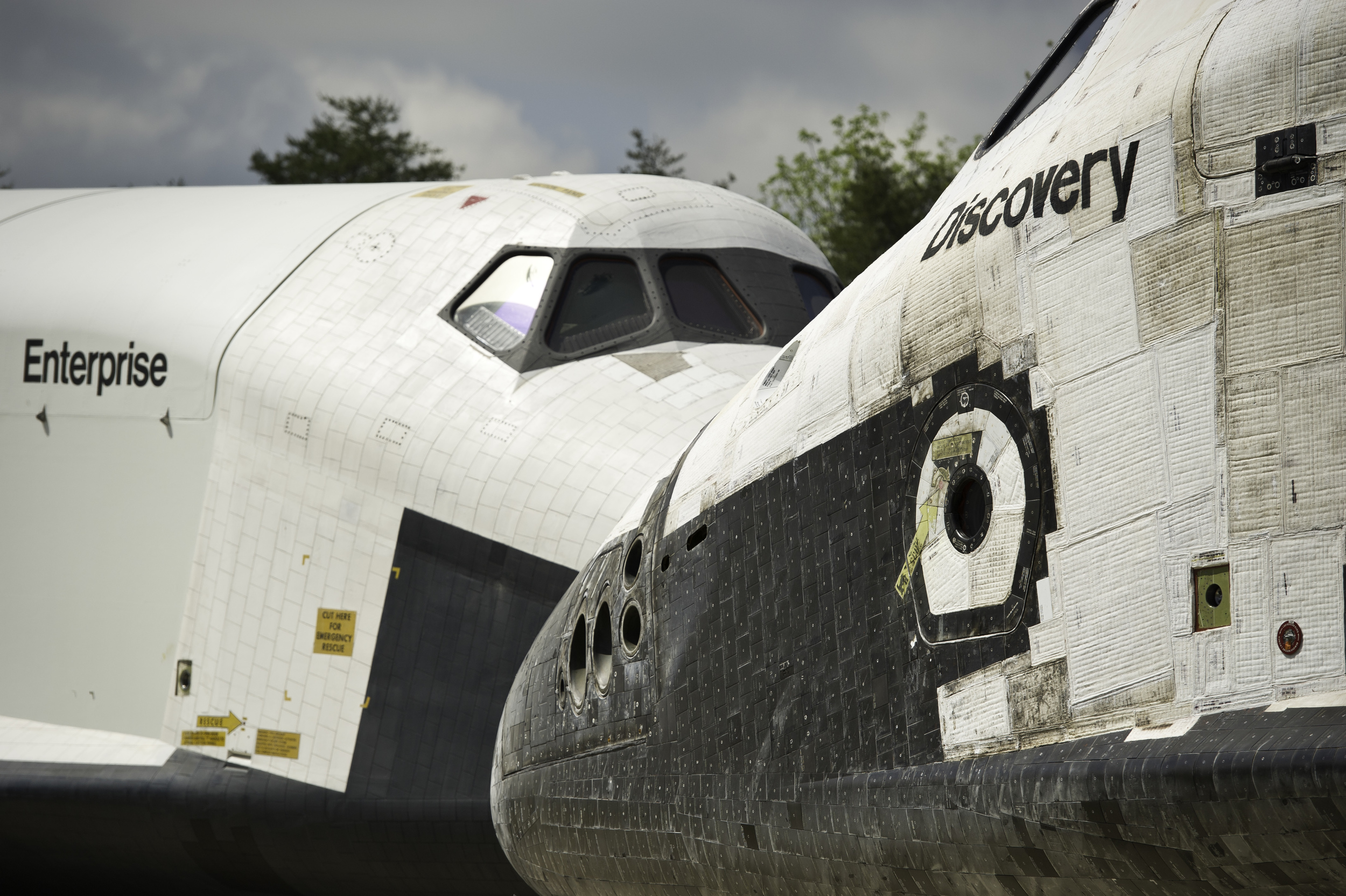 Space Shuttles Enterprise, left, and Discovery meet nose-to-nose during the a transfer ceremony at the Smithsonian's Steven F. Udvar-Hazy Center, Thursday, April 19, 2012, in Chantilly, Va. Space shuttle Discovery, the first orbiter retired from NAS