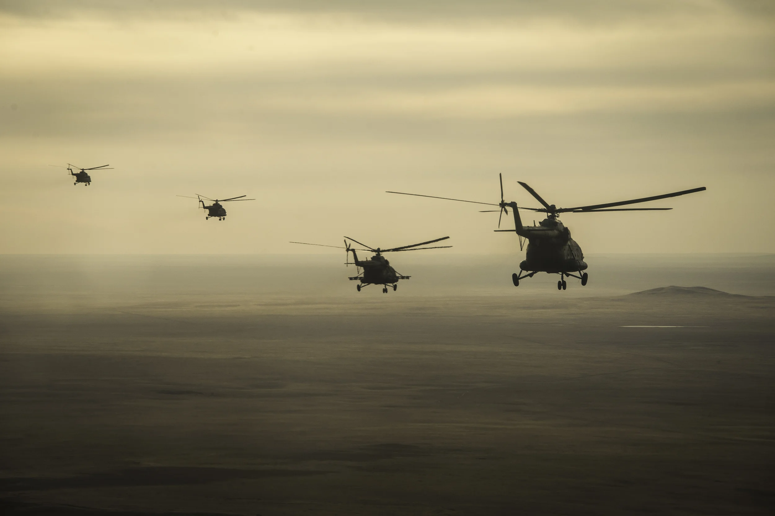 Russian search and rescue helicopters are seen en route to Zhezkazgan airport in Kazakhstan, Sunday, Nov. 10, 2013, a day ahead of the scheduled landing of the Soyuz TMA-09M spacecraft with Expedition 37 Commander Fyodor Yurchikhin of the Russian Federal Space Agency (Roscosmos), Flight Engineer Karen Nyberg of NASA and Flight Engineer Luca Parmitano of the European Space Agency. Yurchikhin, Nyberg and Parmitano are returning to Earth after five and a half months on the International Space Station. (NASA/Carla Cioffi)