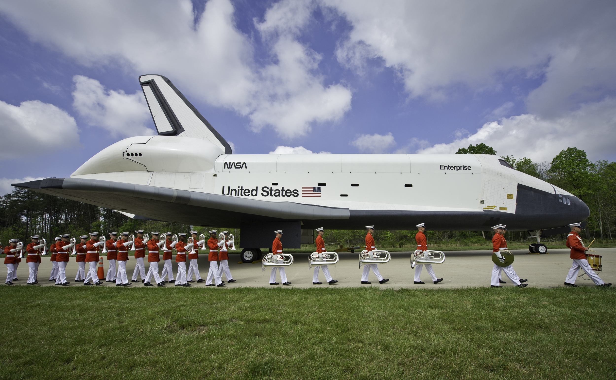 Space shuttle Enterprise is seen as the United States Marine Corp Drum and Bugle Corps and Color Guard march by at the Steven F. Udvar-Hazy Center Thursday, April 19, 2012 in Chantilly, Va. Enterprise was the first space shuttle orbiter, built for N