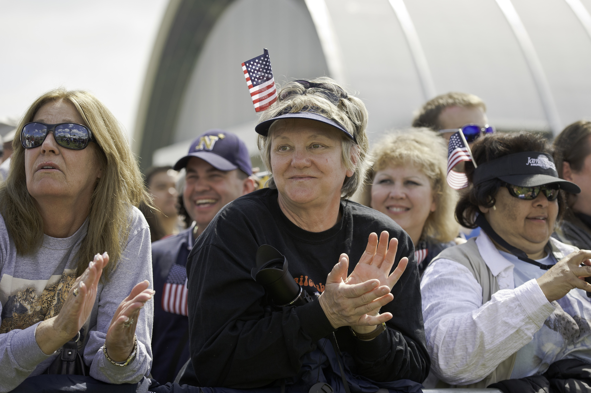 Bettye Kozlowski, center, and Francesca Wright, right, from Santa Clarita, CA attend the transfer ceremony for space shuttle Discovery, Thursday, April 19, 2012, at the Smithsonian's Steven F. Udvar-Hazy Center in Chantilly, Va. Discovery, the first