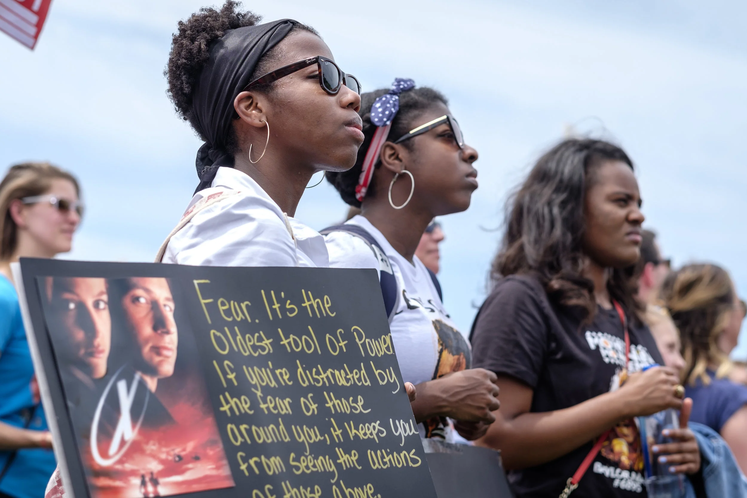 Danielle May, left, and her sister Hailey May, center, are seen as they listen to speakers at the March for Truth DC rally held on the National Mall on Saturday, June 3, 2017 in Washington, DC. The sisters came from New York City to attend the protest. Danielle spoke for both herself and her sister offering, “We are here because we have seen an assault on our institutions since the election. We are here to find out the truth, not necessarily just Russia meddling into our elections, but also every institution we’ve seen so far with the appointments in the Trump administration, including our Attorney General Jeff Sessions, including the other appointees to national security and other matters. We think that investigations are warranted and that whatever information is uncovered needs to be clearly expressed to every American citizen. This can no longer be behind closed doors. We all need to know.”