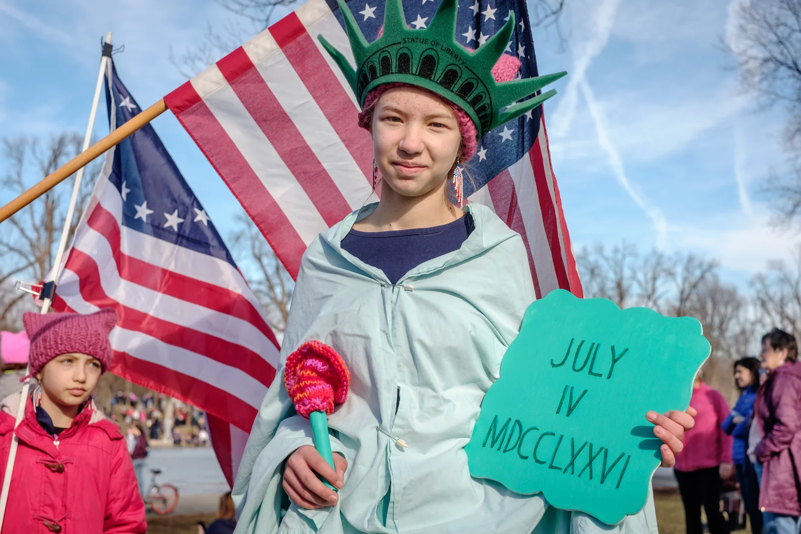 Maddie Smith, from Maryland, is seen at the anniversary of the Women’s March on Saturday, January 20, 2018 in Washington, DC. I photographed her earlier in 2017 at the March for Truth DC, so it was a great surprise to run in to her in such a large gathering. I asked her why she came to this event and she offered, “Because I support democracy, the rule of law and everything that Lady Liberty stands for.” Thousands of people gathered at the Lincoln Memorial for the anniversary of the Women’s March DC, and for March on the Polls with the goal of advancing peaceful and positive progress in communities across the country, and ensuring all women and their allies persist in civic and political roles moving into 2018. Sister marches took place around the country and around the world.