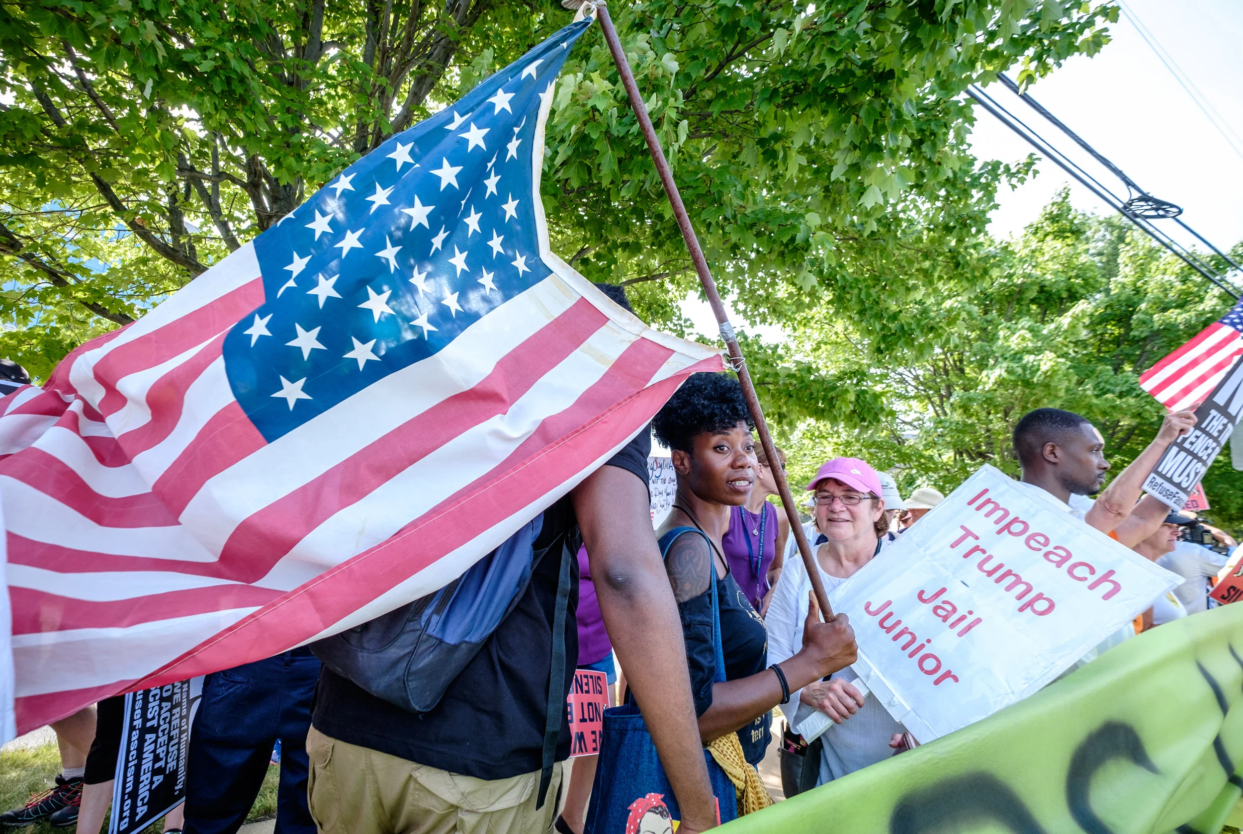 Tamara Lee, from NYC, is seen at the Women’s March From #NRA2DOJ rally at the National Rifle Association Headquarters in Fairfax, VA on Friday, July 14, 2017. “I am … doing a research project on The Gathering for Justice, which is the umbrella organization that houses the Women’s March, also the Justice League New York. And I think the important thing is that we have to protect the First Amendment rights to be out here, so when we have a propaganda that labels us as not peaceful. This is a tactic that we’ve seen before and we do the same thing we did then, which is to stand peacefully and say who we are. Right? So we’re doing that. Also there is a problem in the country with the Second Amendment not being applied equally to black and brown folks. And we would like the NRA, if they are the organization that they say they are, to actually stand up for the rights of lawfully owning gun owners who are black and brown. So this is also about Philando Castile, which brings us to a larger issue. These are the intersectional issues that we’re looking at where race and equality and women’s rights, they’re all tied together. … And so if we can’t stand and resist this government peacefully then we don’t have first amendment rights. If we don’t have first amendment rights, you don’t have second amendment rights. And if we don’t have fourteenth amendment rights what are we here for? So that’s why I’m here.” The Women’s March from #NRA2DOJ is a demonstration against the NRA taking no action in response to the Philando Castile trial verdict. Following the rally demonstrators marched 18 miles from the NRA to the Department of Justice in Washington, DC.