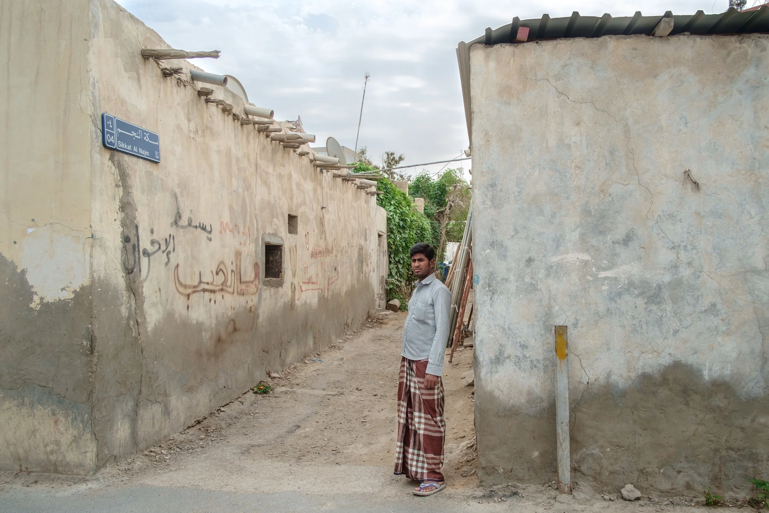 A blue-collar expat is seen in the old Musheireb neighborhood of Doha. Much of this neighborhood has been torn down, and the residents forcibly removed, in order to build the New Msheireb development. Qatar is in a race to revitalize and modernize in time to host the 2022 FIFA World Cup.
