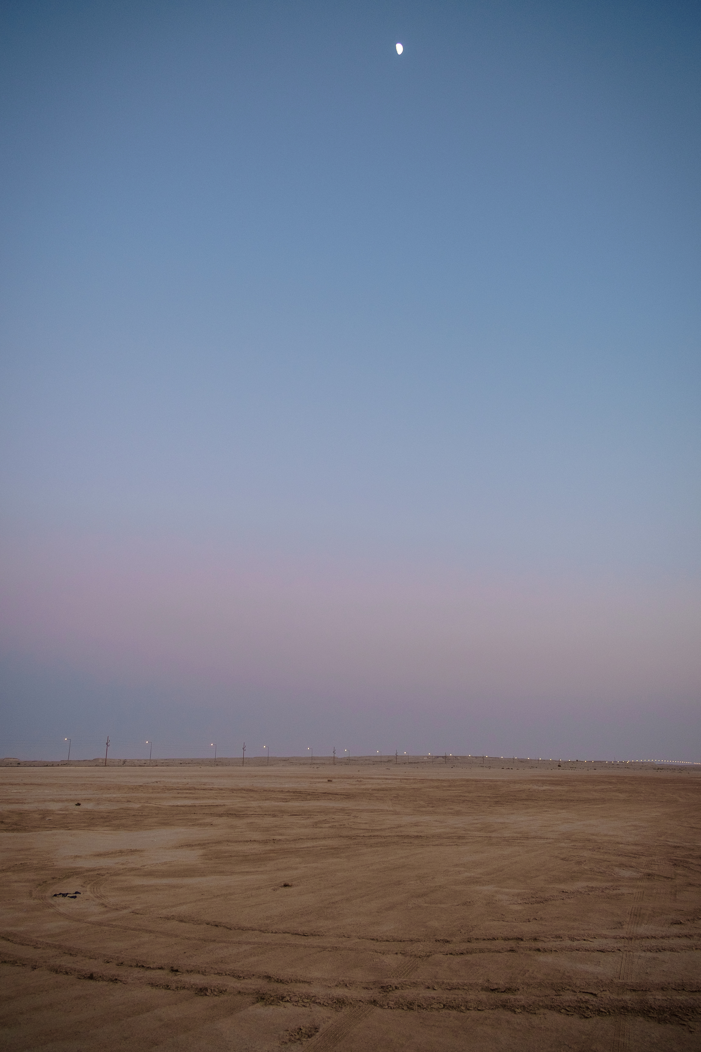  The moon is seen rising above the desert in Zekreet at dusk. 