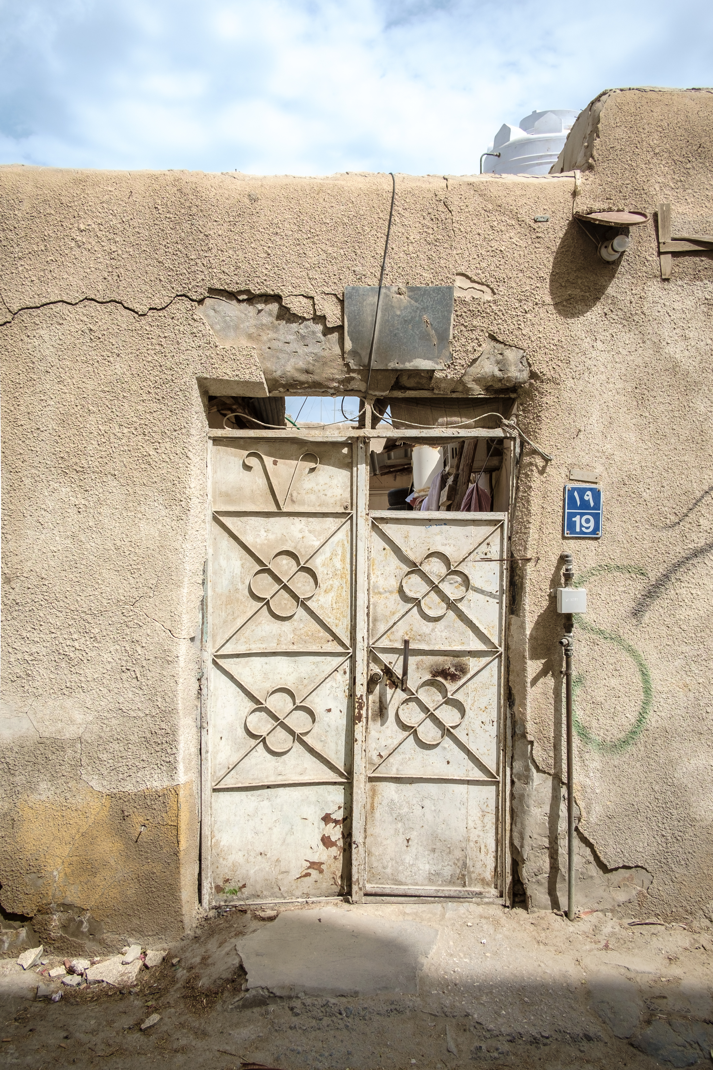  The door of a residential compound in the old Musheireb neighborhood of Doha. Much of this neighborhood has been torn down, and the residents forcibly removed, in order to build the New Msheireb development. Qatar is in a race to revitalize and mode