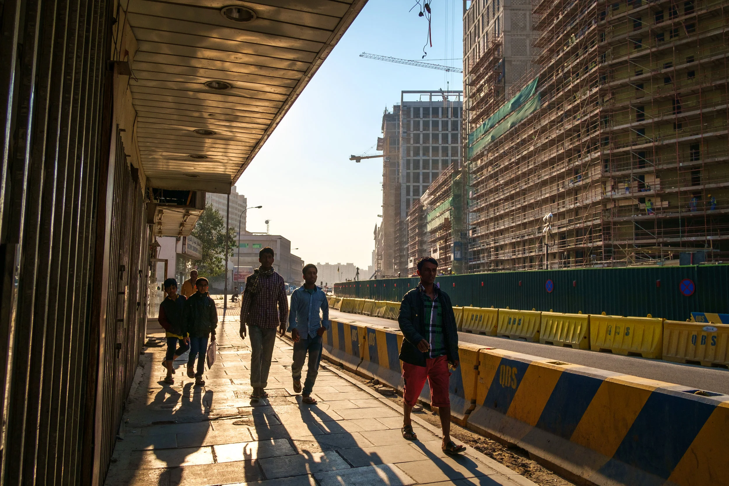 A street scene in the old Musheireb neighborhood of Doha with the new Msheireb development rising above it. Much of this old part of Doha has been torn down as Qatar races to revitalize and modernize in time to host the 2022 FIFA World Cup.