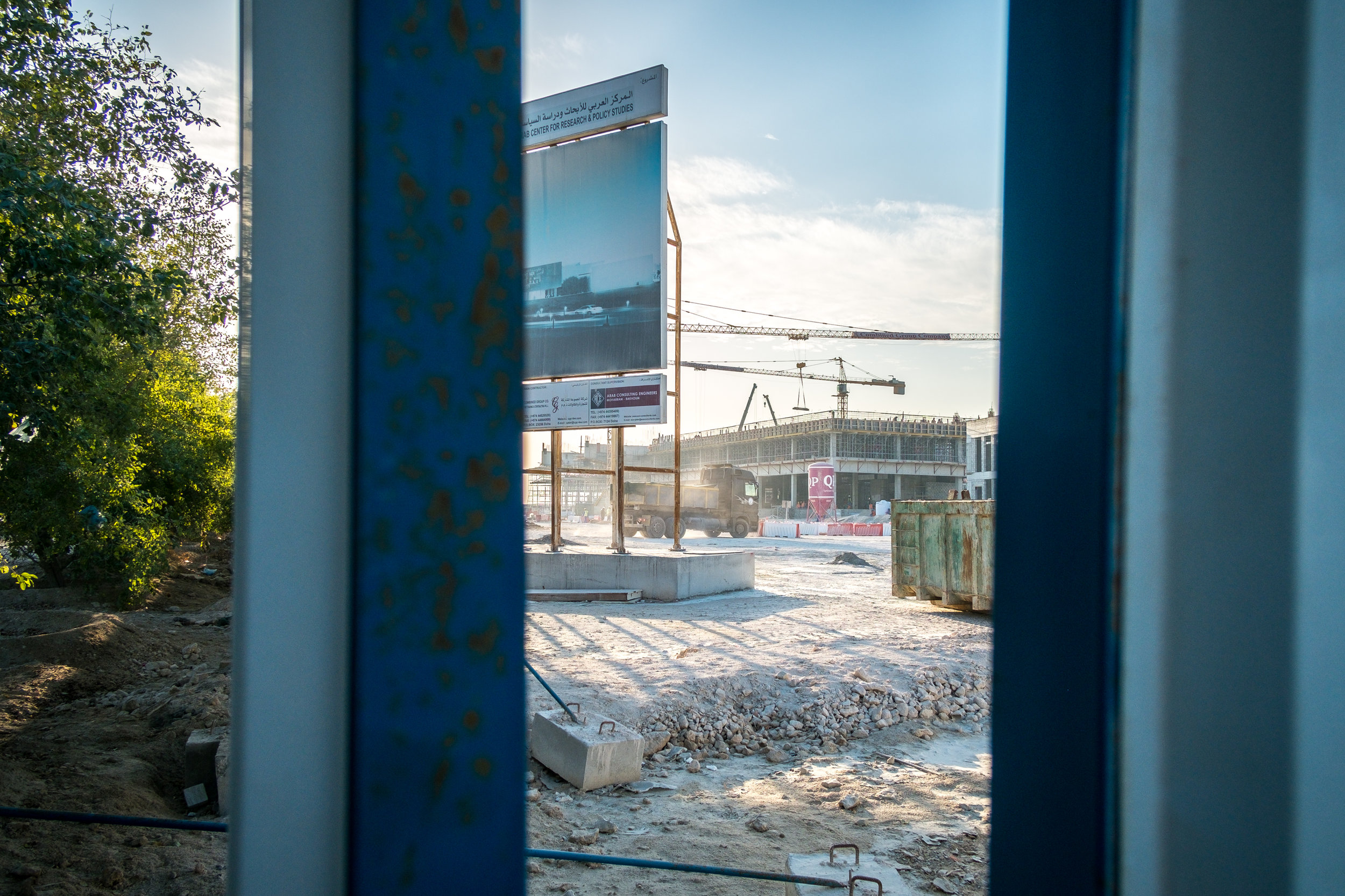  A construction site for the Arab Center for Research and Policy Studies is seen through a crack in the partition. 