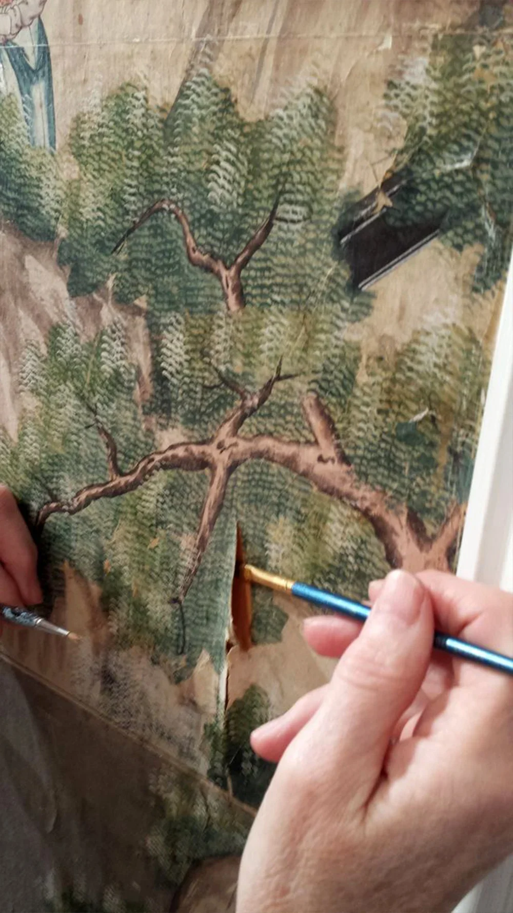 Handpainted Chinese wallpaper during restoration