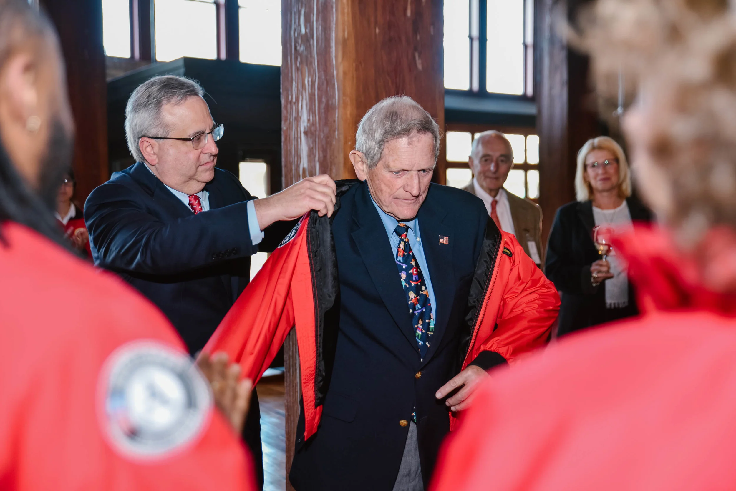 Michael Brown jackets John Morgridge after his dedication