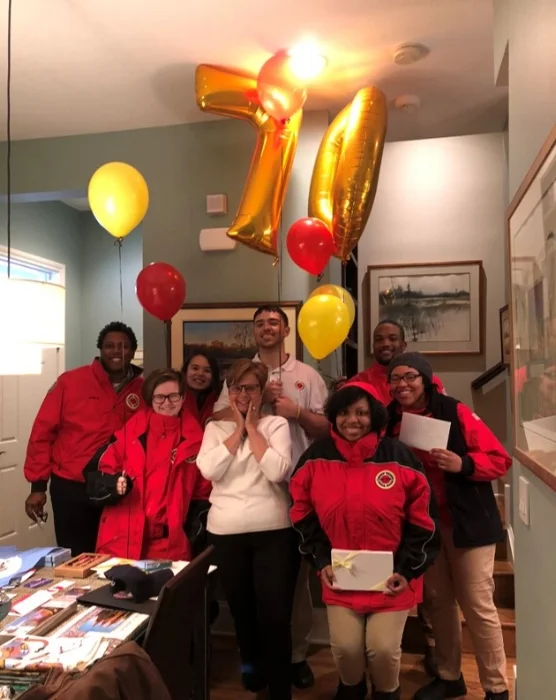 City Year AmeriCorps Members, including Patric (top right), celebrating Anne's (center) birthday