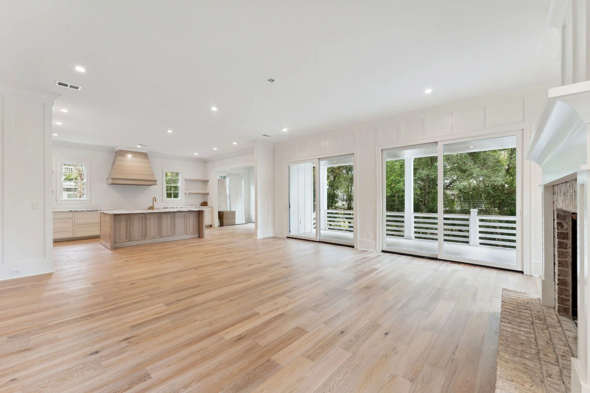 Great room open to the kitchen, with the fireplace on the right.