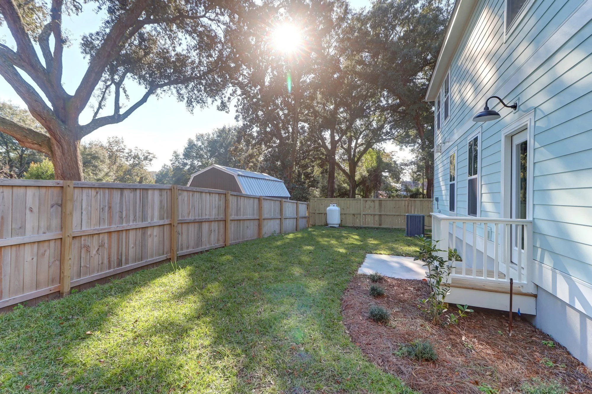 Rear yard shaded by live oaks at a custom Mount Pleasant SC home by Iconic Developments