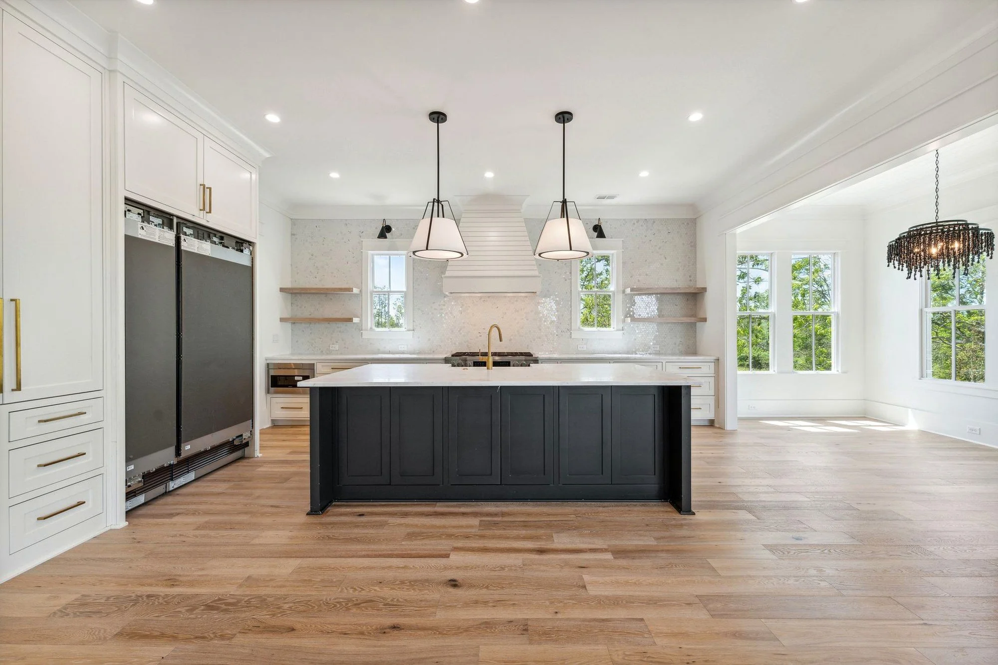 Luxury custom kitchen island and wood range hood in a Daniel Island SC coastal home