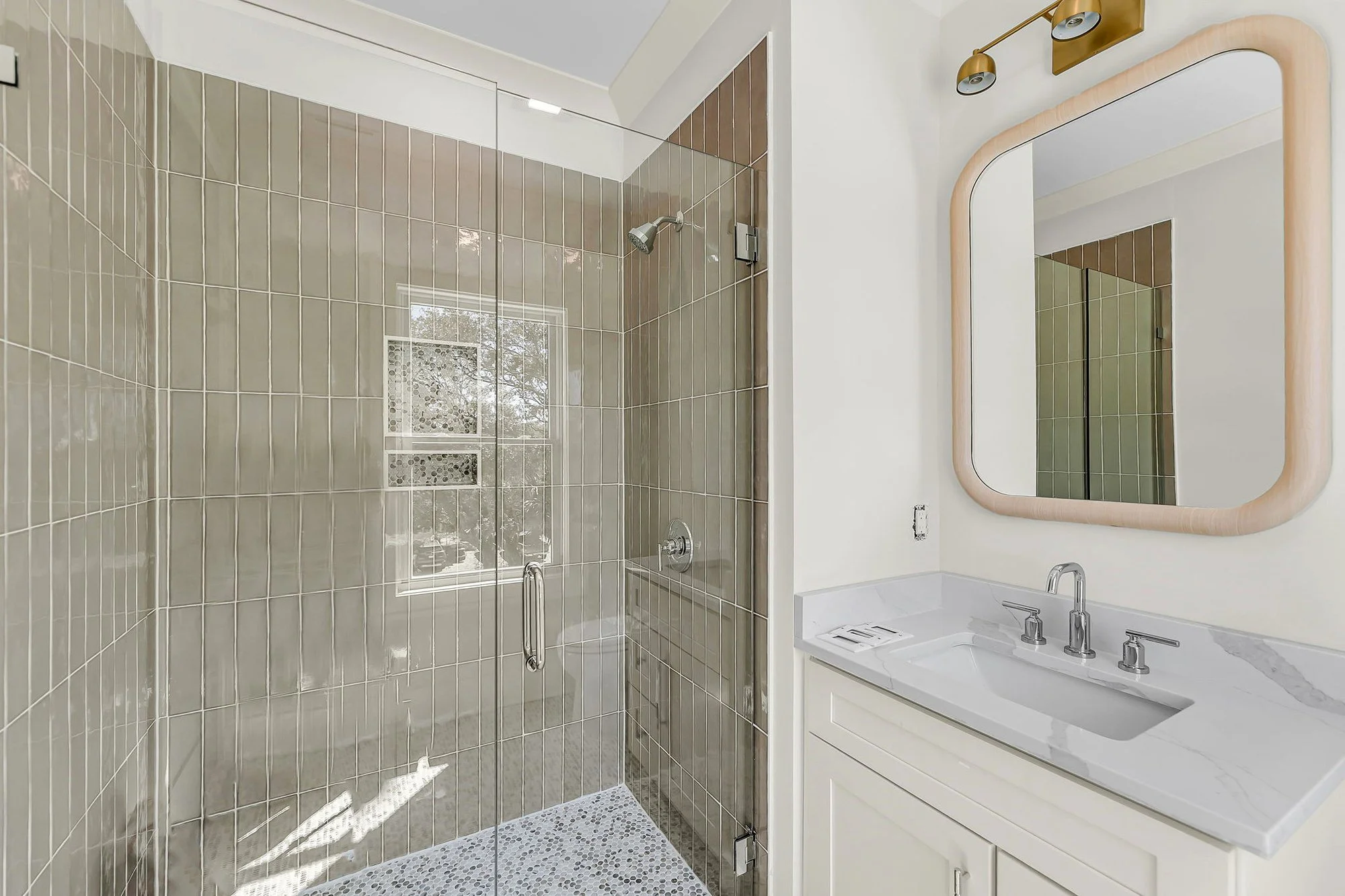 Frameless glass shower and custom tilework in an Isle of Palms SC luxury guest bath