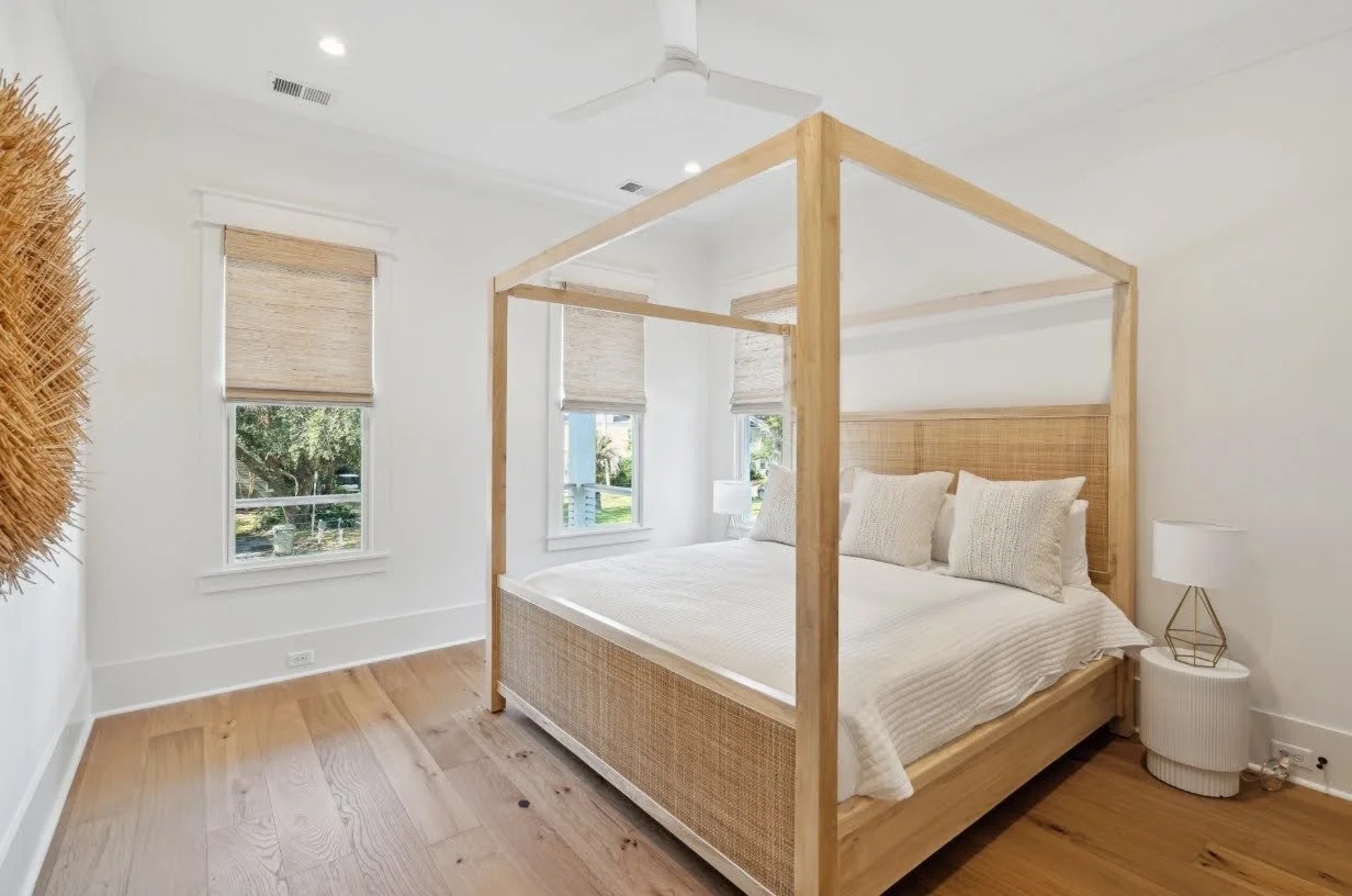 Guest bedroom with canopy bed in a coastal Isle of Palms SC home by Iconic Developments