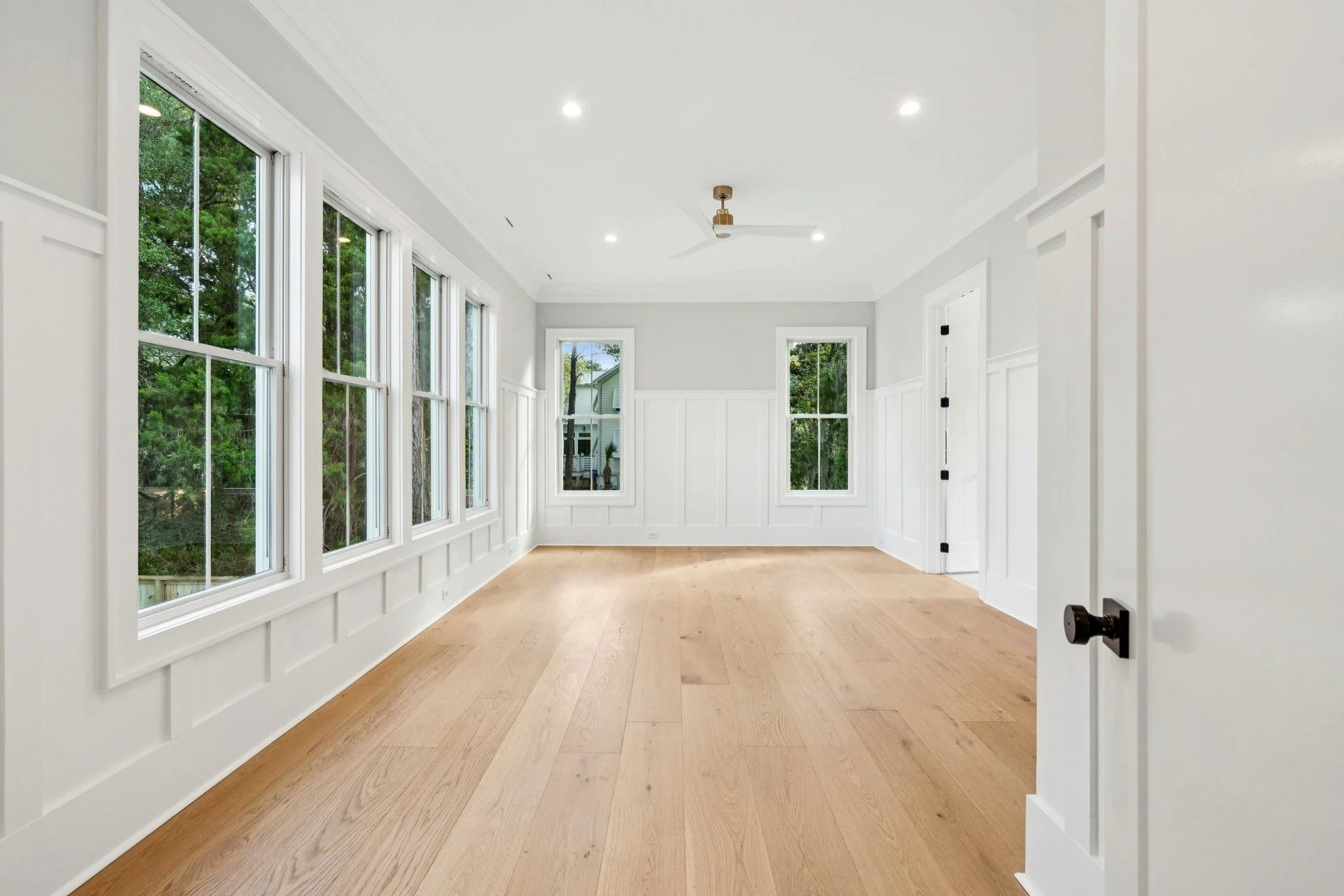 Primary bedroom with window wall and marsh views on Isle of Palms SC by Iconic Developments