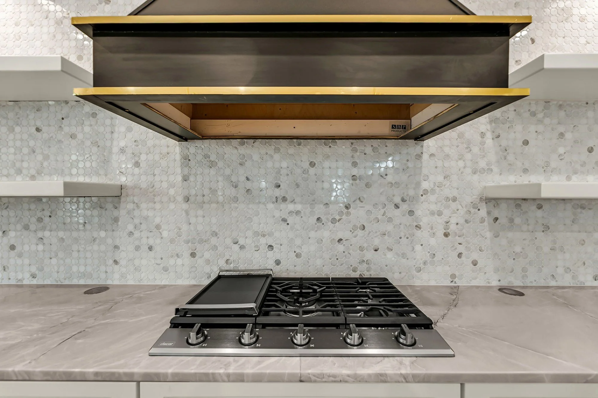 Professional gas cooktop and custom hood detail in an Isle of Palms SC luxury kitchen