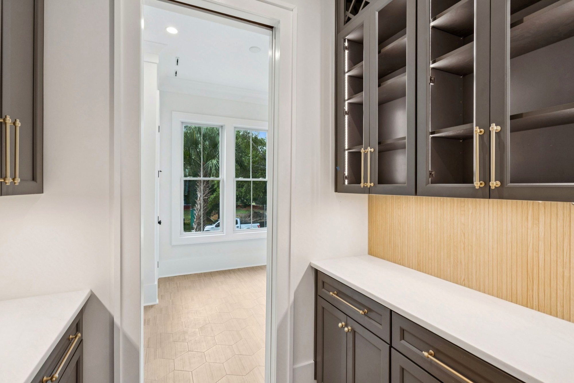 Butler pantry with brass hardware and inset cabinetry in a Charleston SC custom home