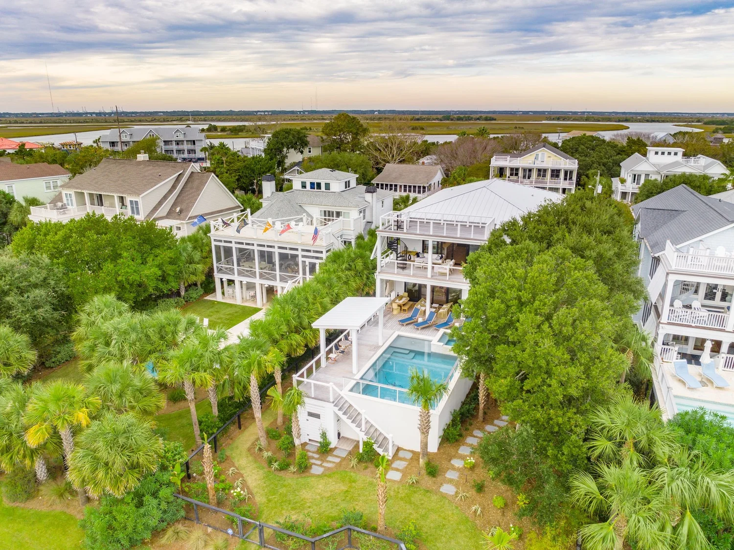 Aerial view of the custom elevated home built by Iconic Developments at 116 Charleston Boulevard on Isle of Palms, SC, showing the pool deck and marsh beyond