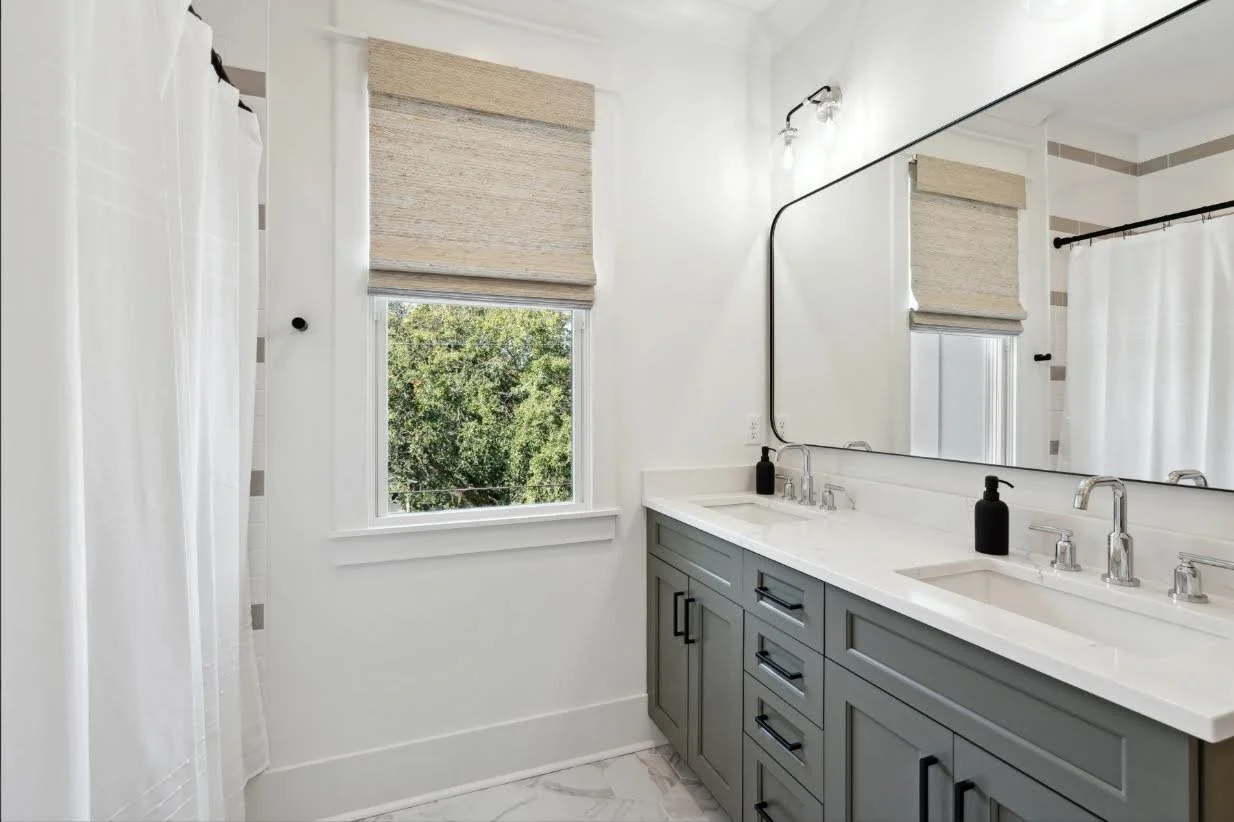Hall bath with custom double vanity in a Charleston SC home by Iconic Developments