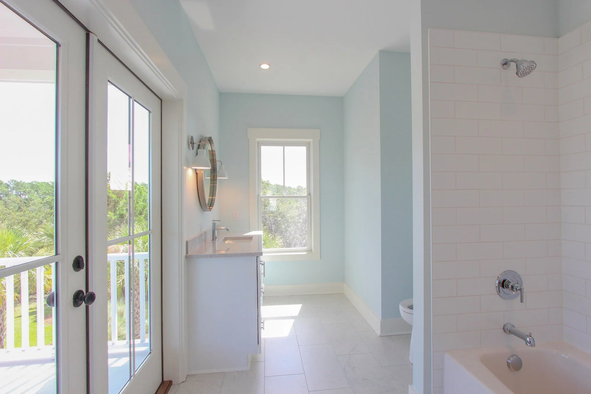 Guest bath with tiled tub and shower combination in a Charleston SC custom home