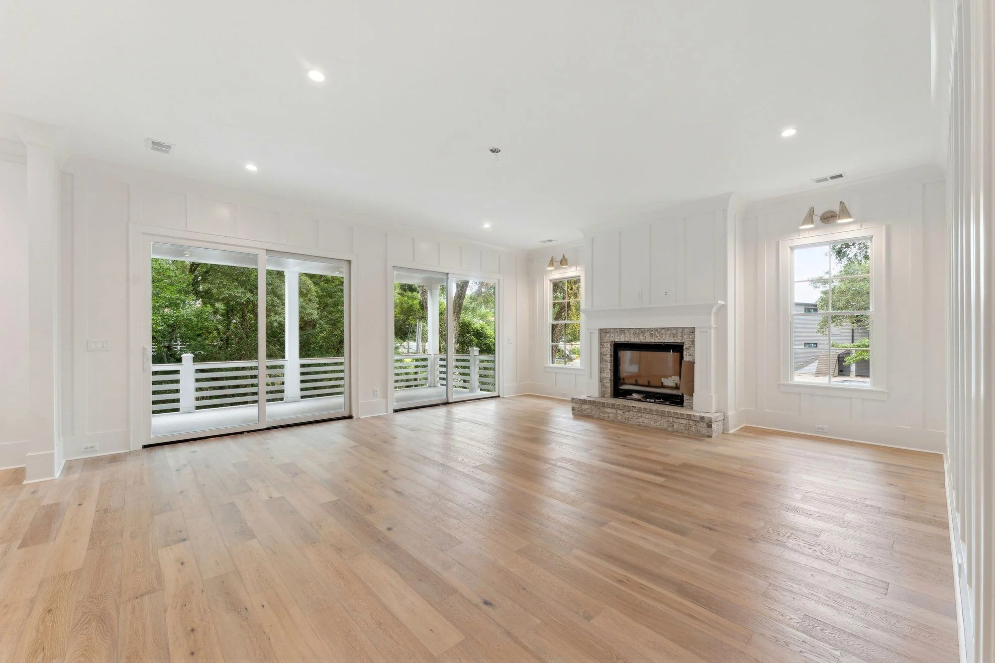 Great room with multi-panel sliders opening to the rear porch.