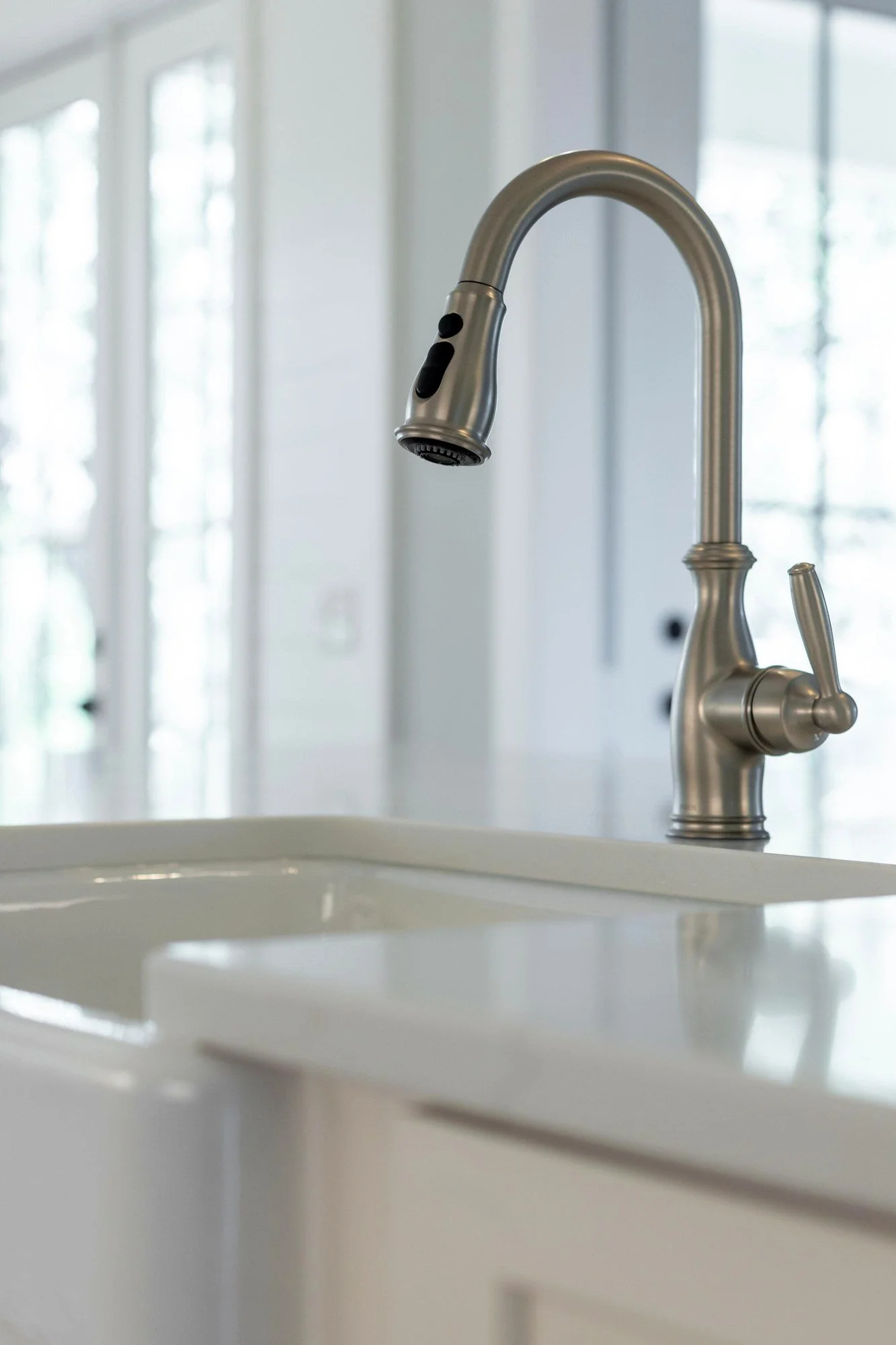Farmhouse sink and bridge faucet detail in a custom Charleston SC luxury kitchen build