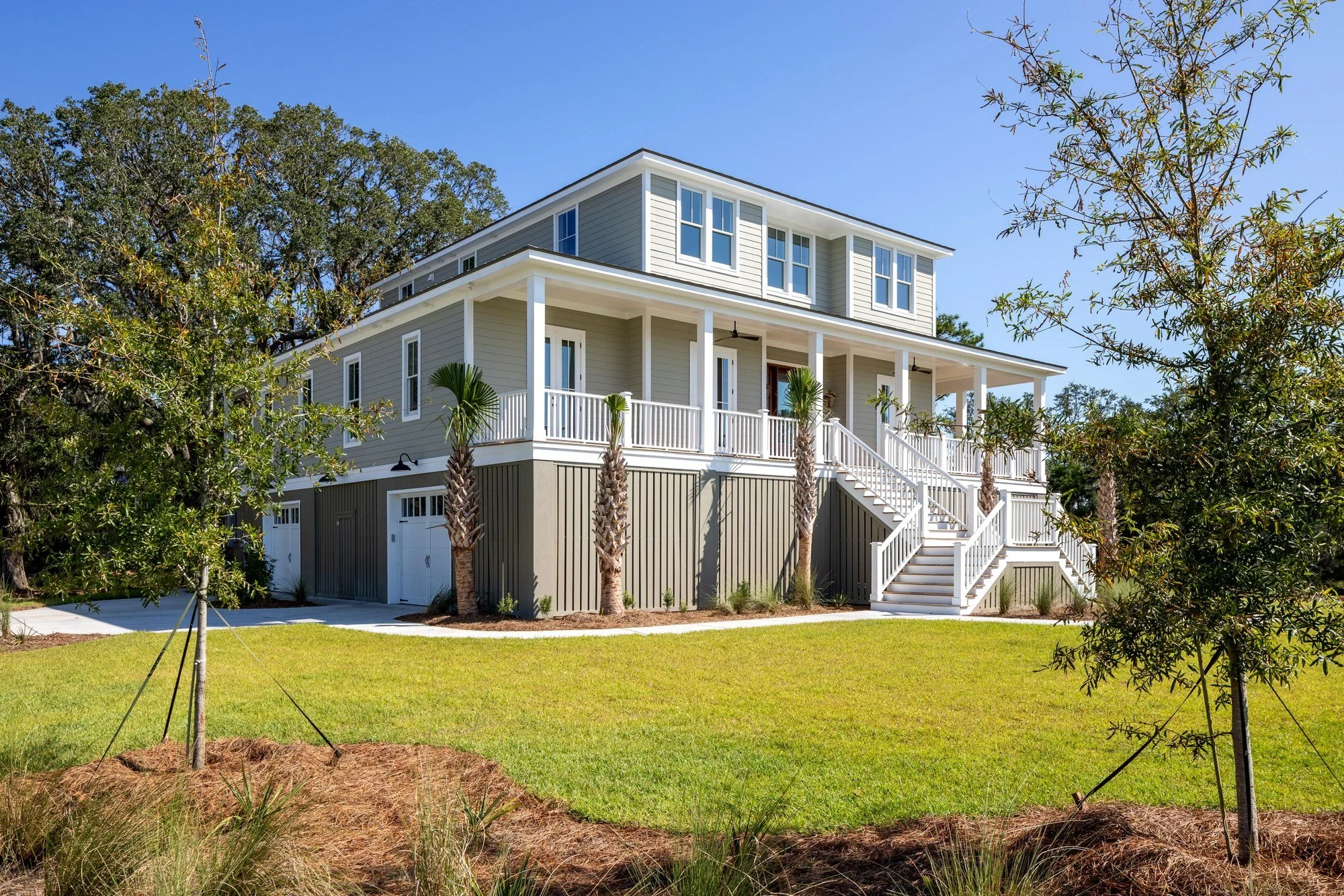 Custom home elevation framed by palmetto landscaping in Charleston SC by Iconic Developments