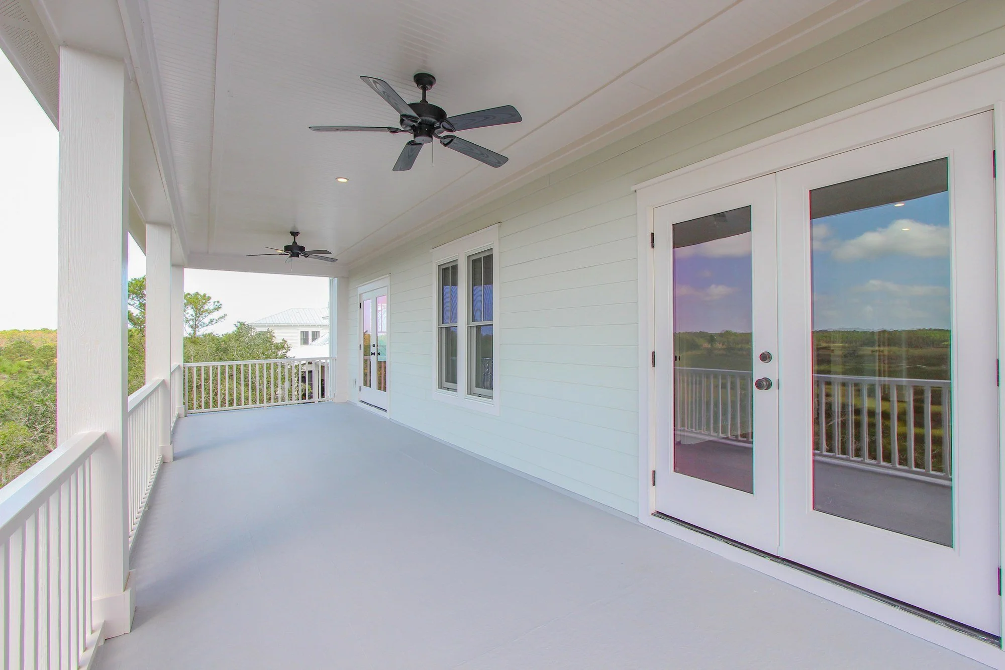 Covered porch with French doors on an elevated Johns Island SC custom home build