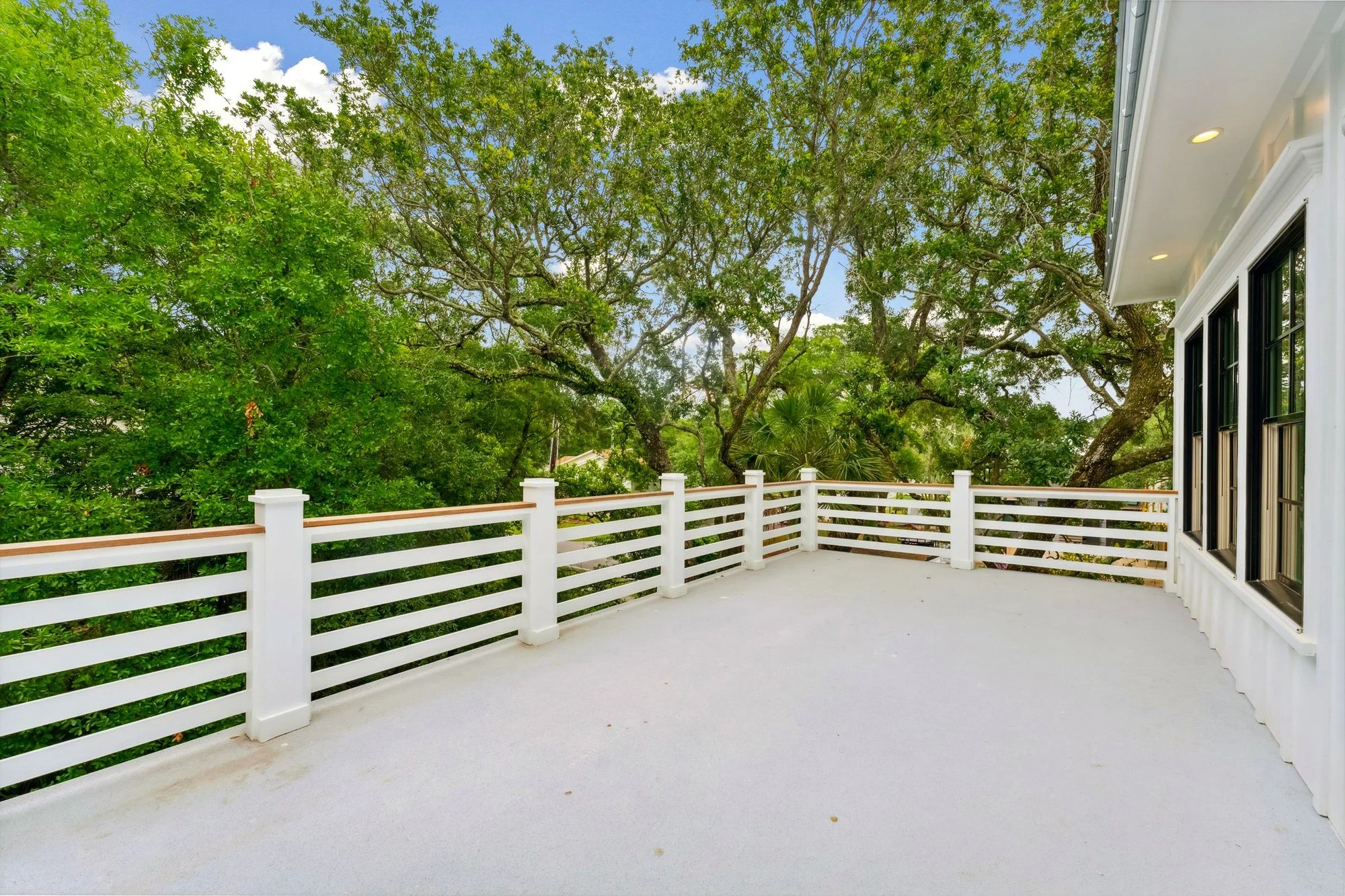 Rear covered porch looking out into the live oaks.