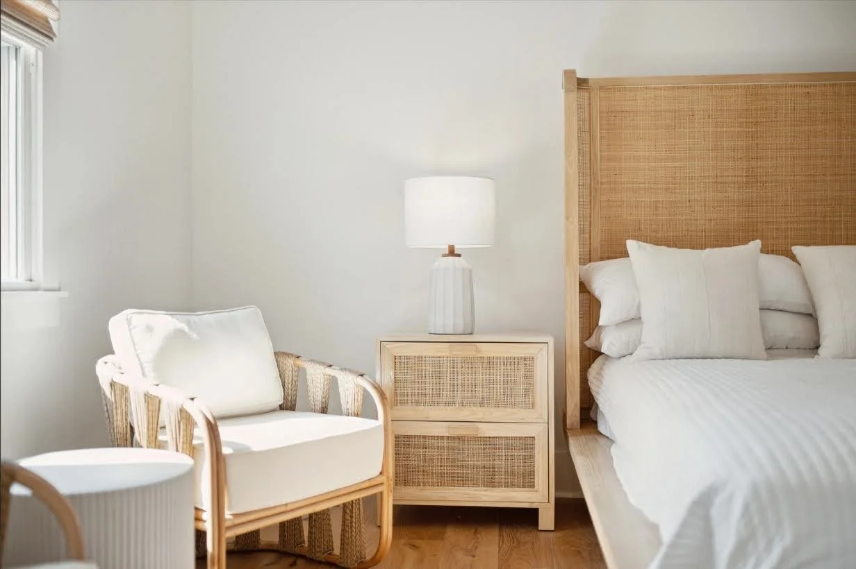 Coastal guest bedroom with rattan headboard in an Isle of Palms SC custom home build