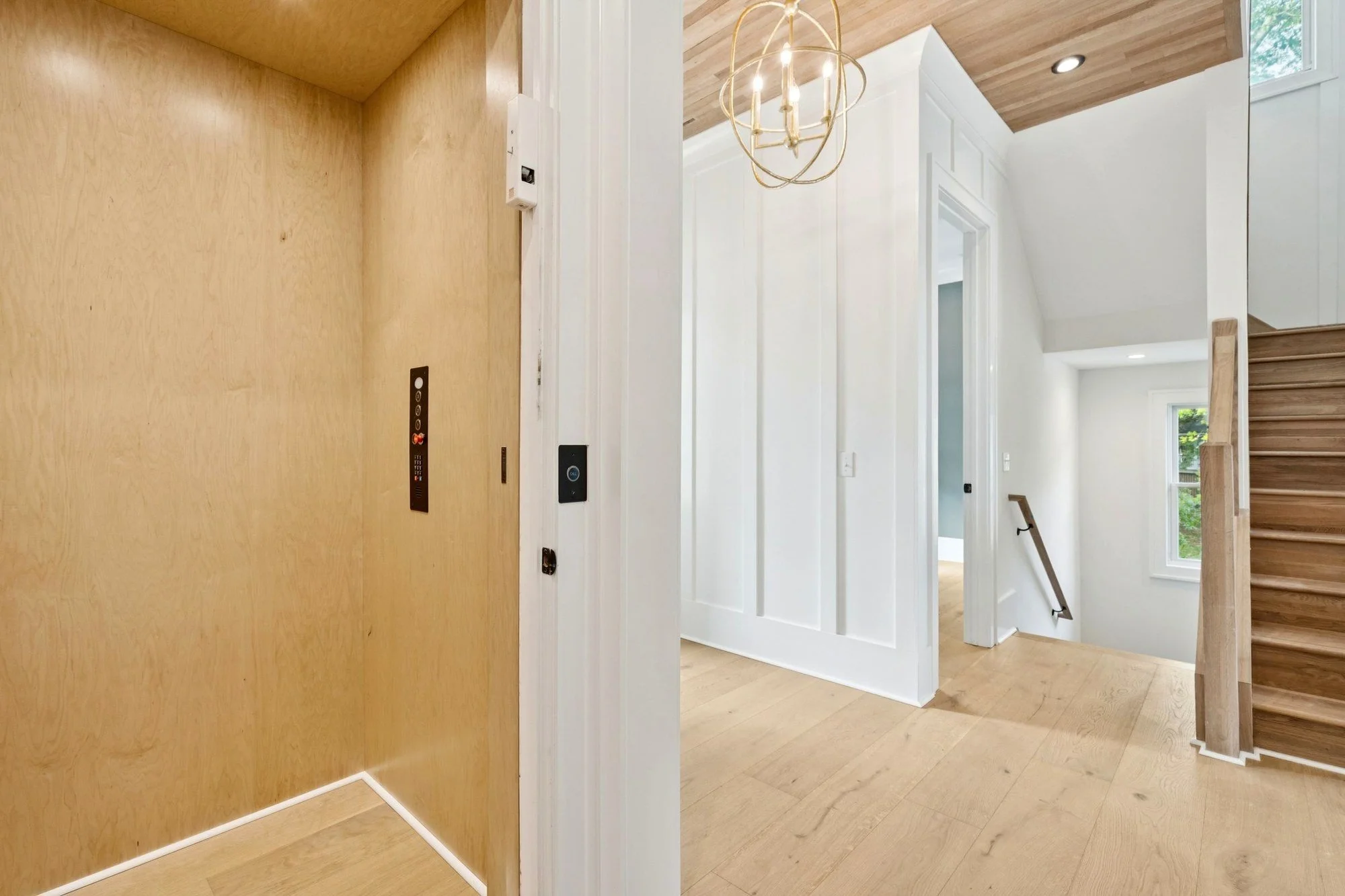 Residential elevator off the entry hall of an elevated Isle of Palms SC custom home